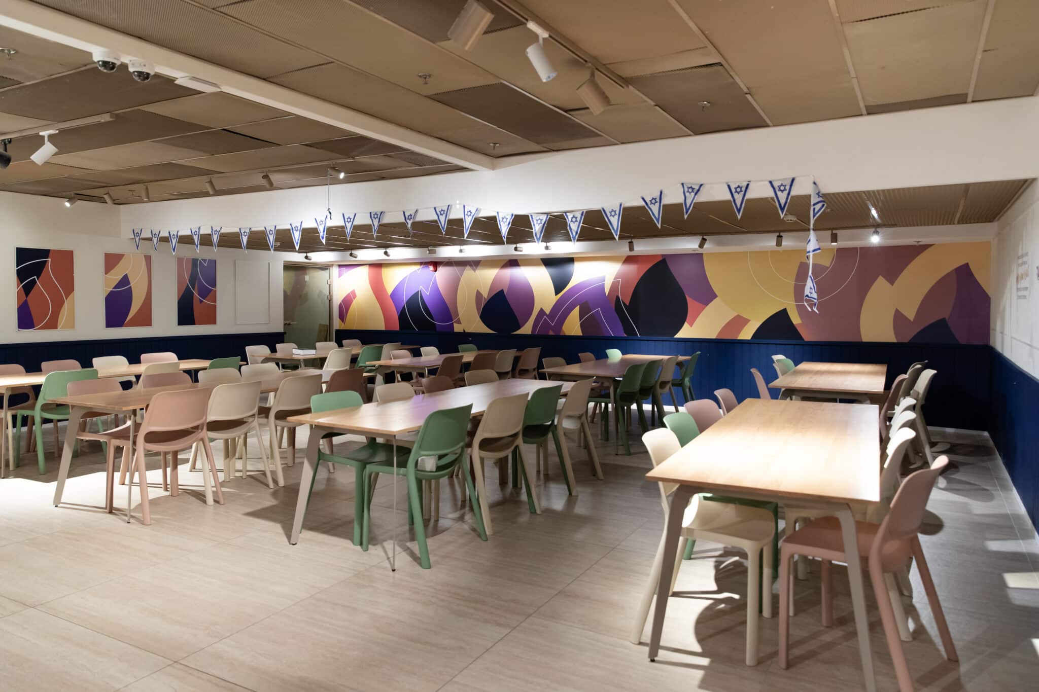 Long abstract wall graphic across the dining hall wall