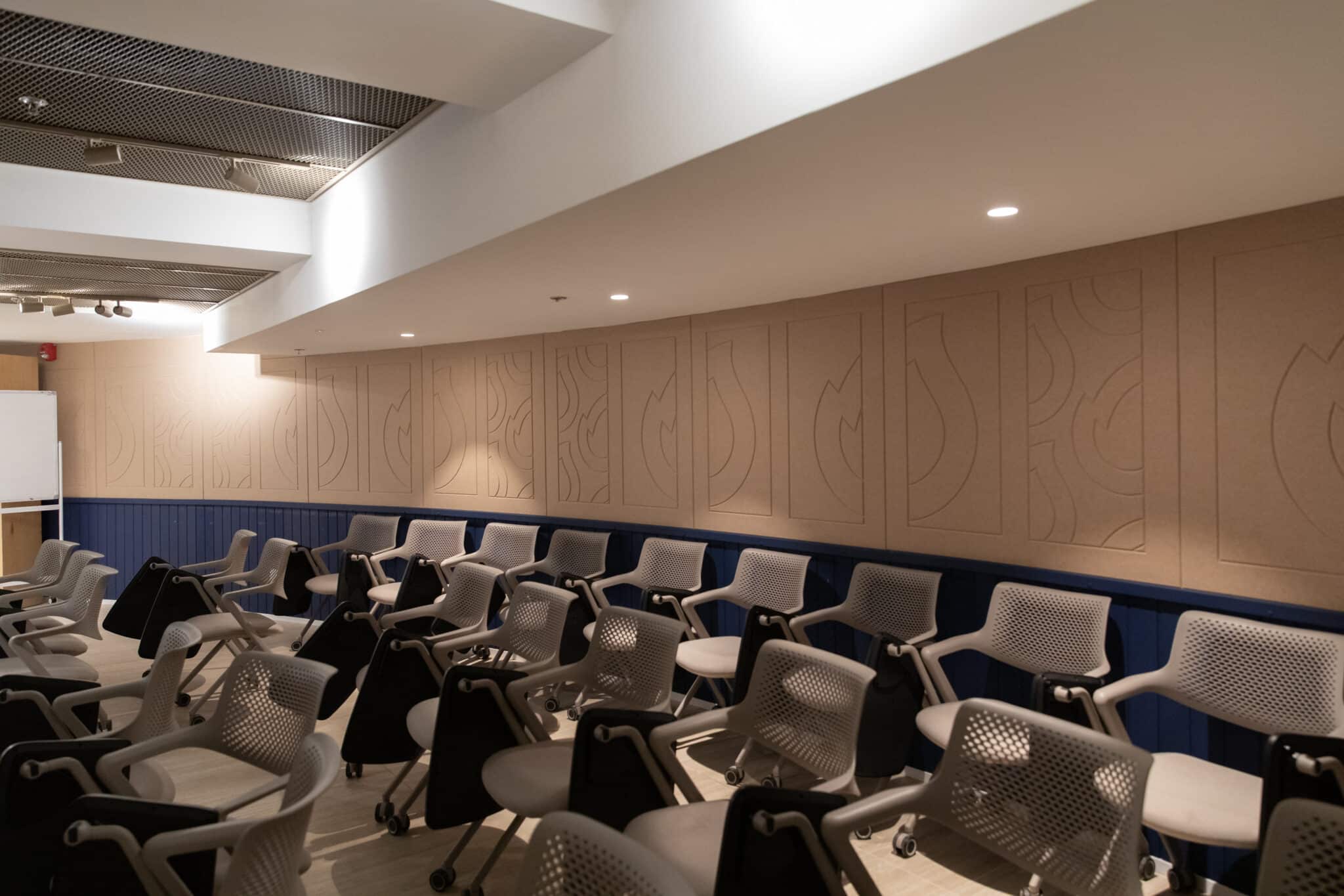 Acoustic panels with routed motifs in a lecture hall