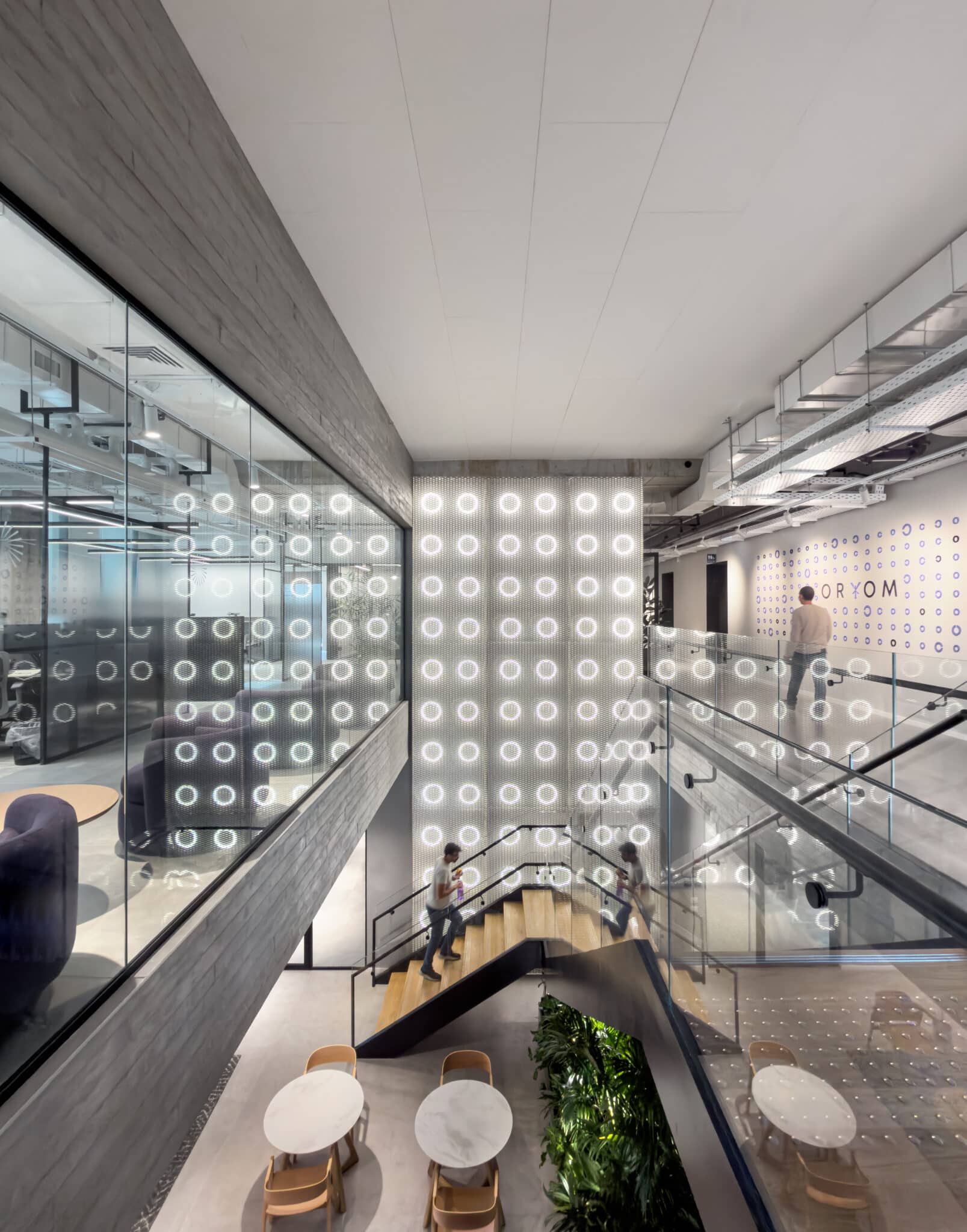 Ring pattern film covering glass around an office atrium stair