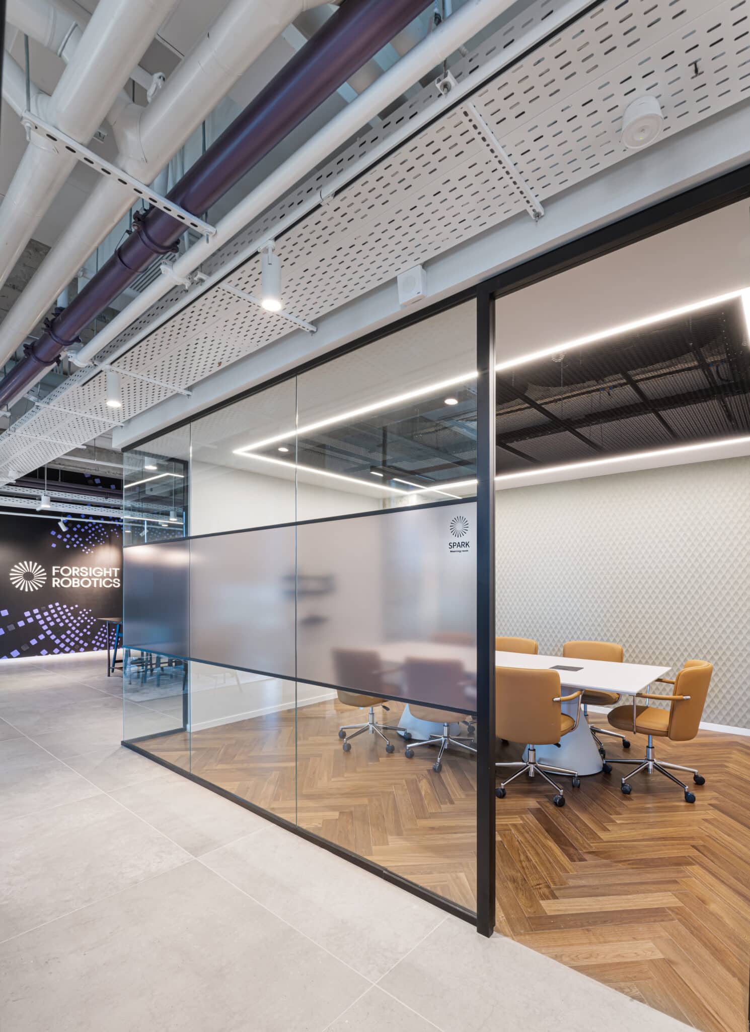 SPARK room signage on a frosted glass band in a meeting room wall