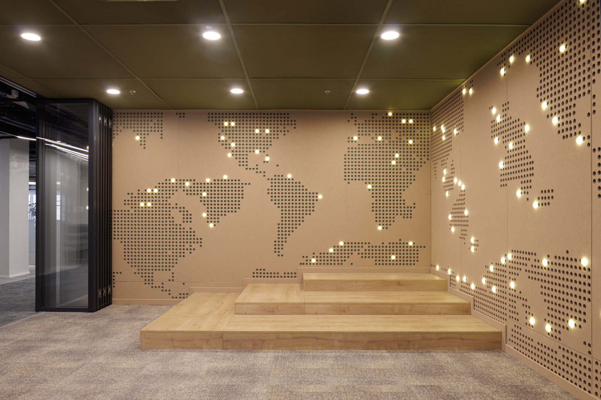 Dotted world map across two walls with pinpoint lights