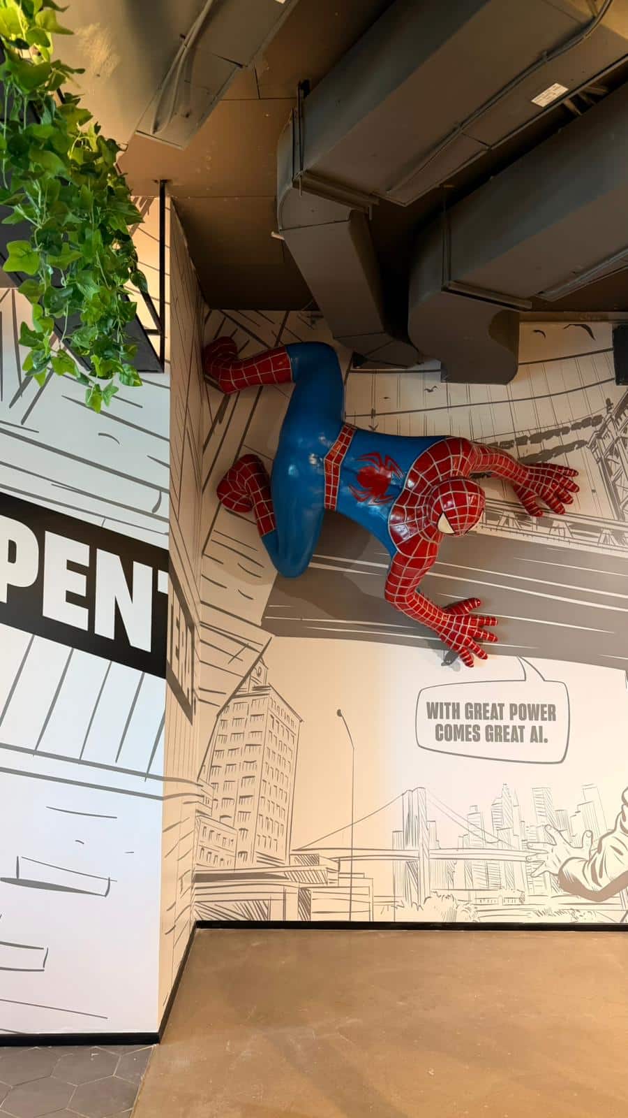 Spiderman figure mounted on a comic strip wall graphic