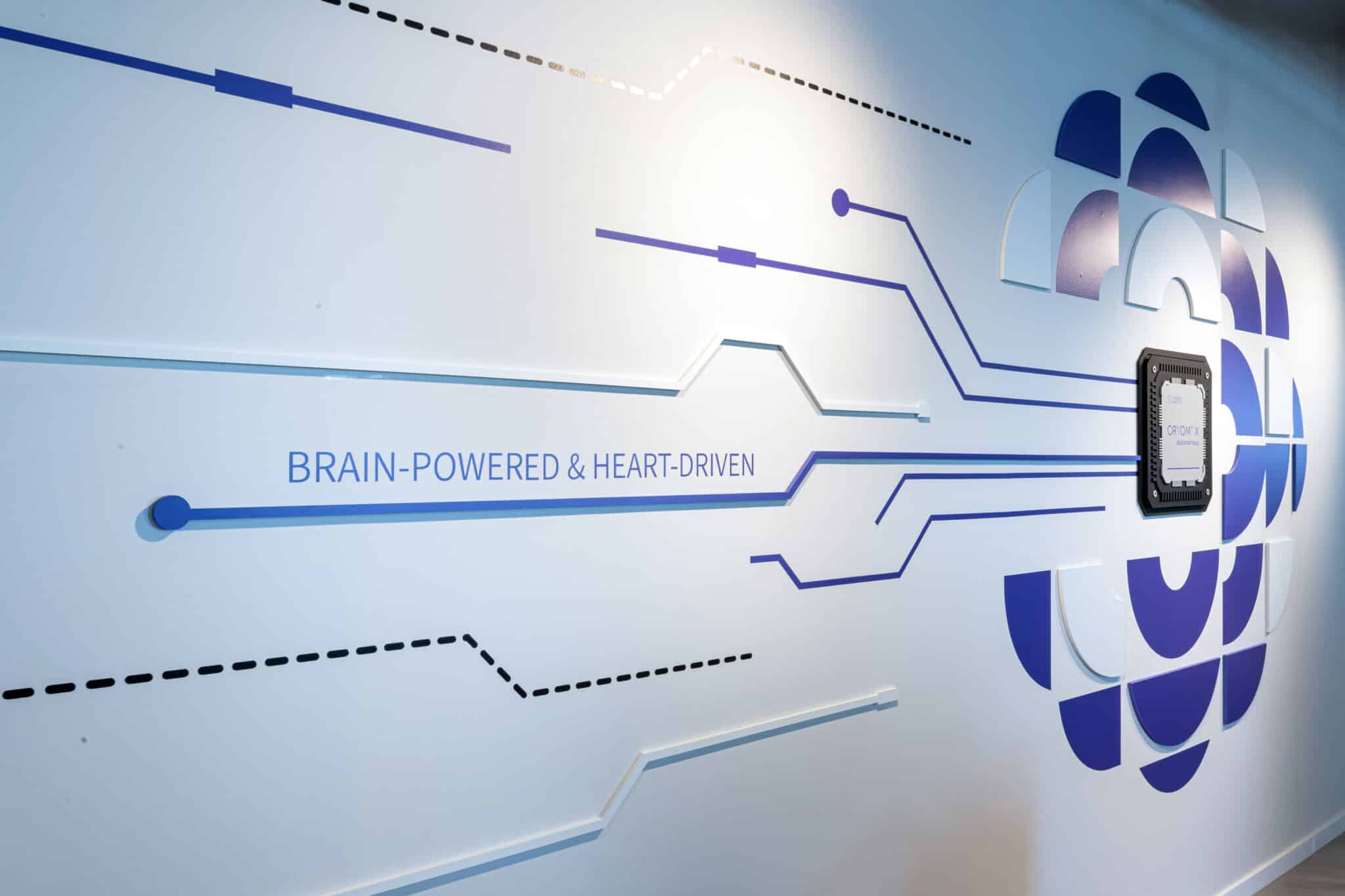 BRAIN-POWERED AND HEART-DRIVEN wall graphic with circuit lines and a logo