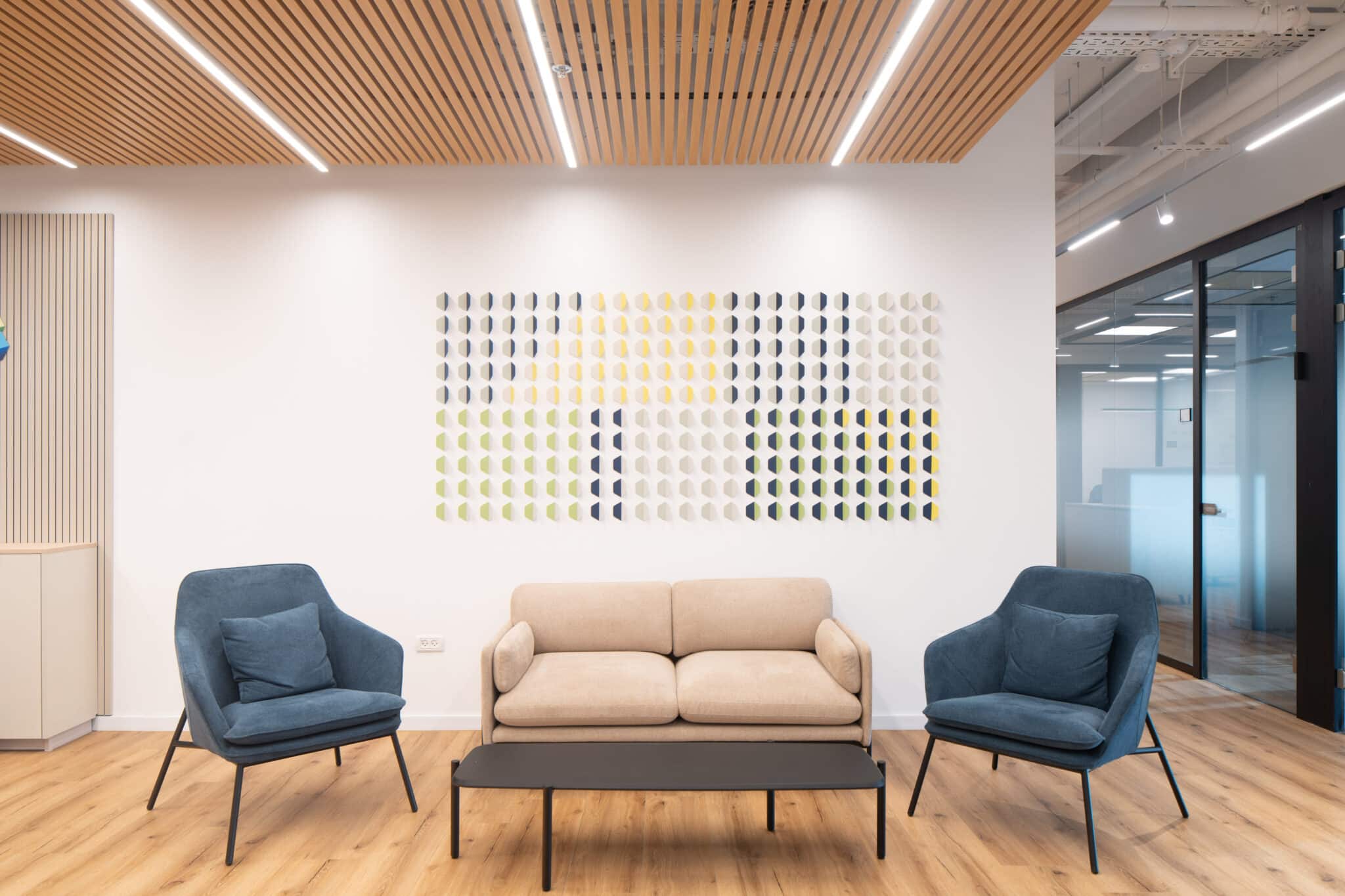 Grid of 3D half-circle tiles in green, yellow and navy above a lounge