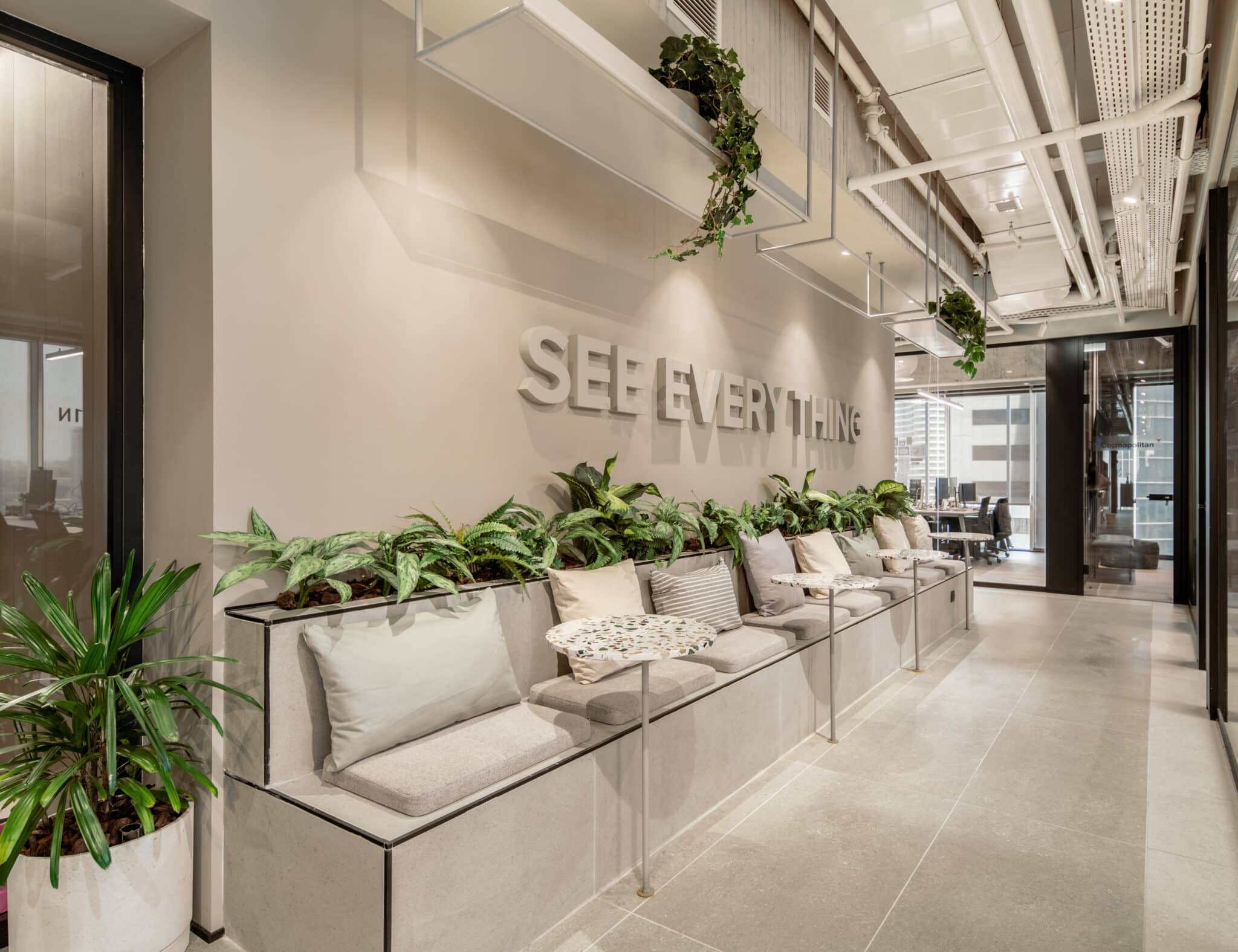 SEE EVERYTHING 3D letters above a planted bench in a corridor