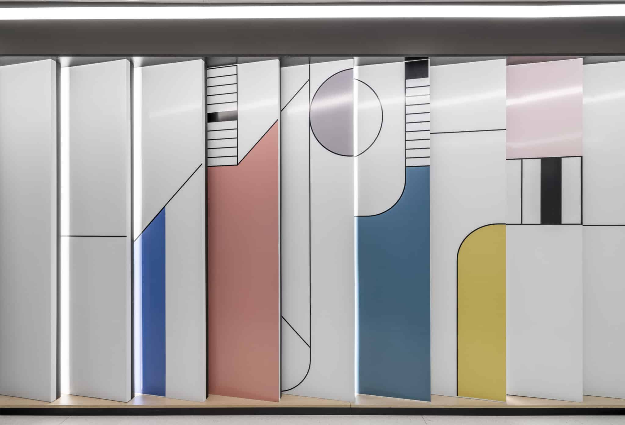 Panelled wall with geometric graphics in blue, coral and yellow