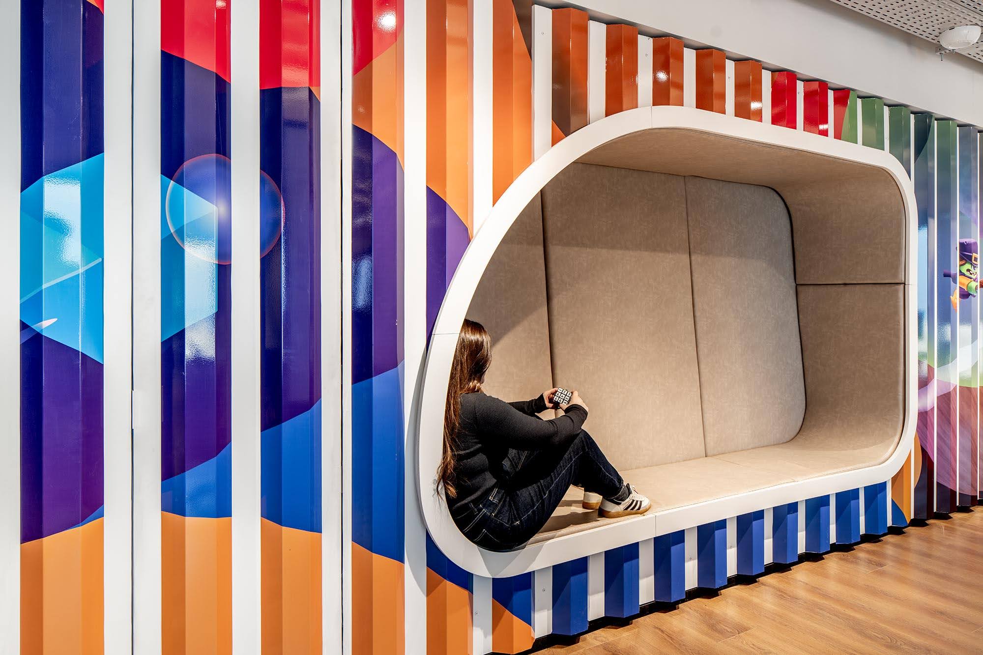 Seating nook set into a striped colour graphic wall