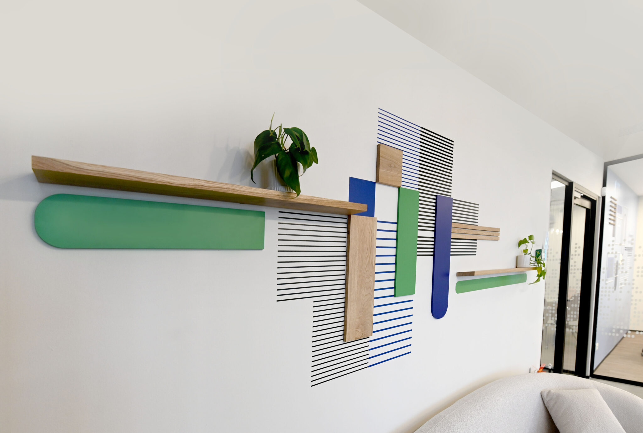 Relief wall of green and blue shapes with wood battens