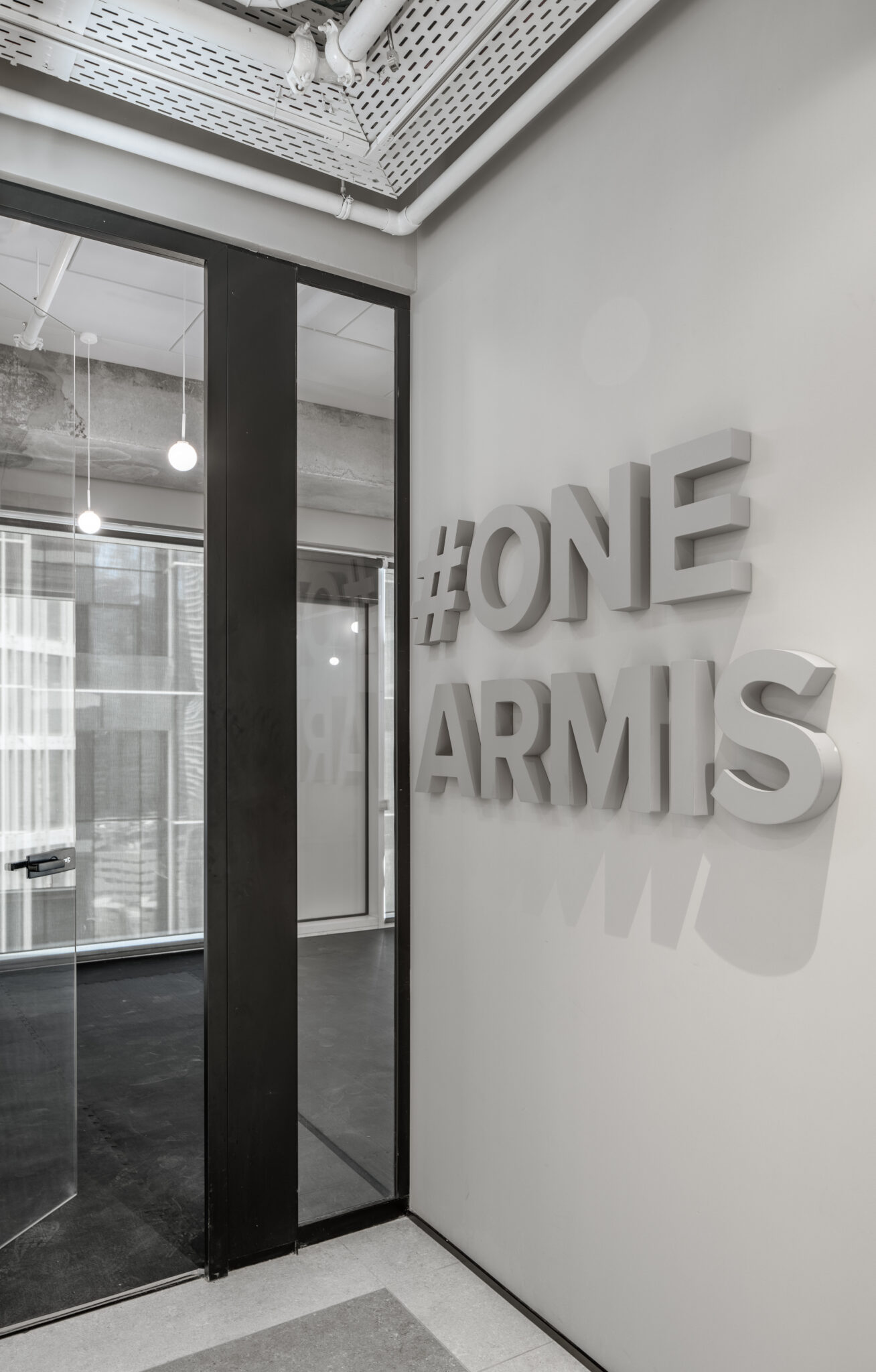 #ONE ARMIS deep 3D letters beside a glass office door