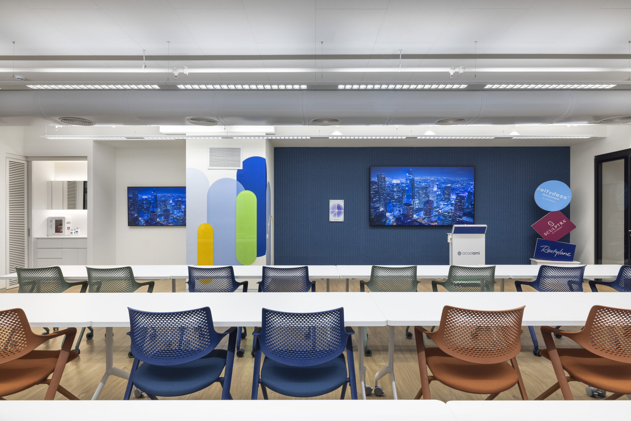 Coloured shape wall graphic and round brand signs in a training room