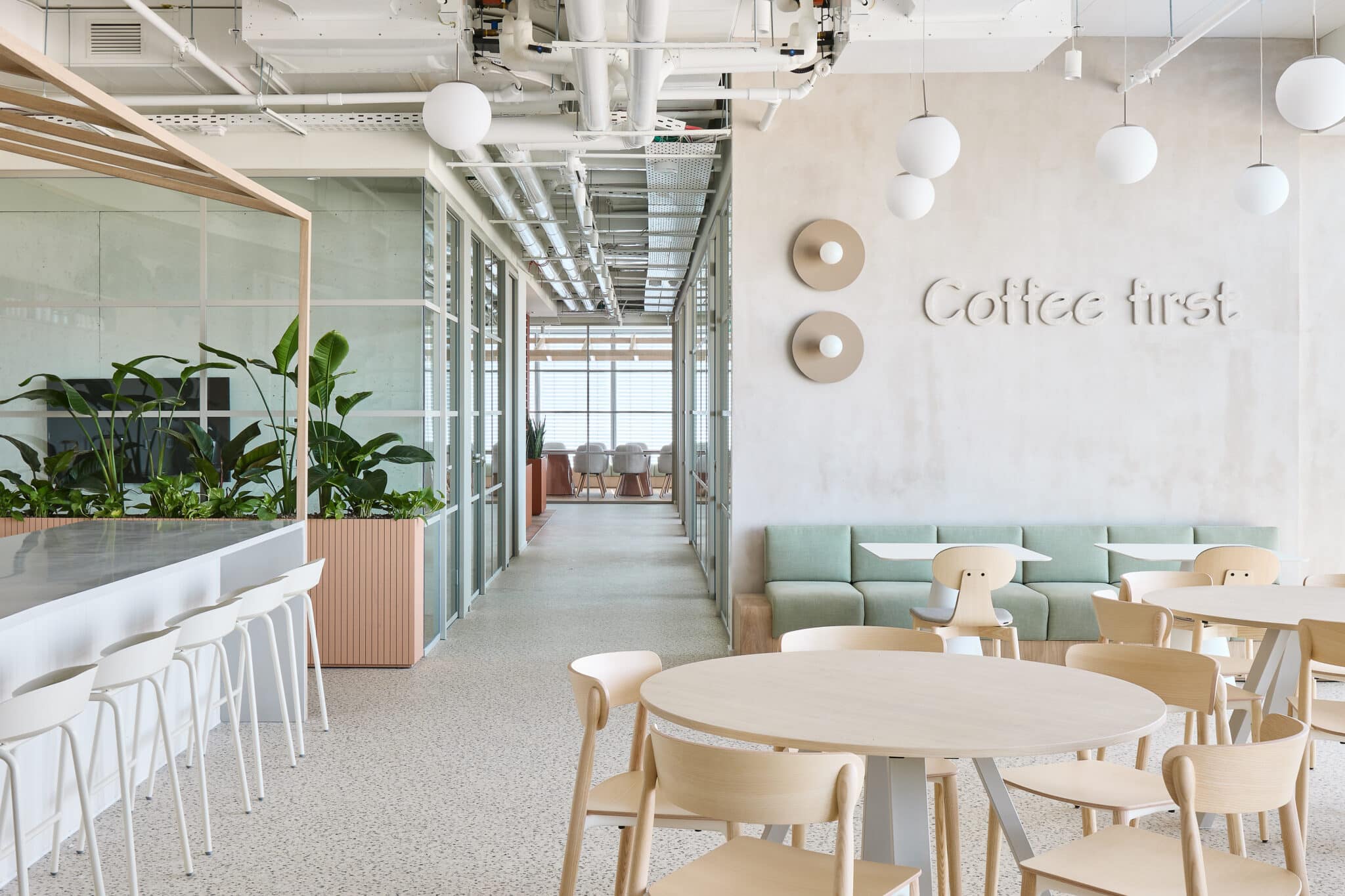Coffee first wall letters and two round discs in the office cafe