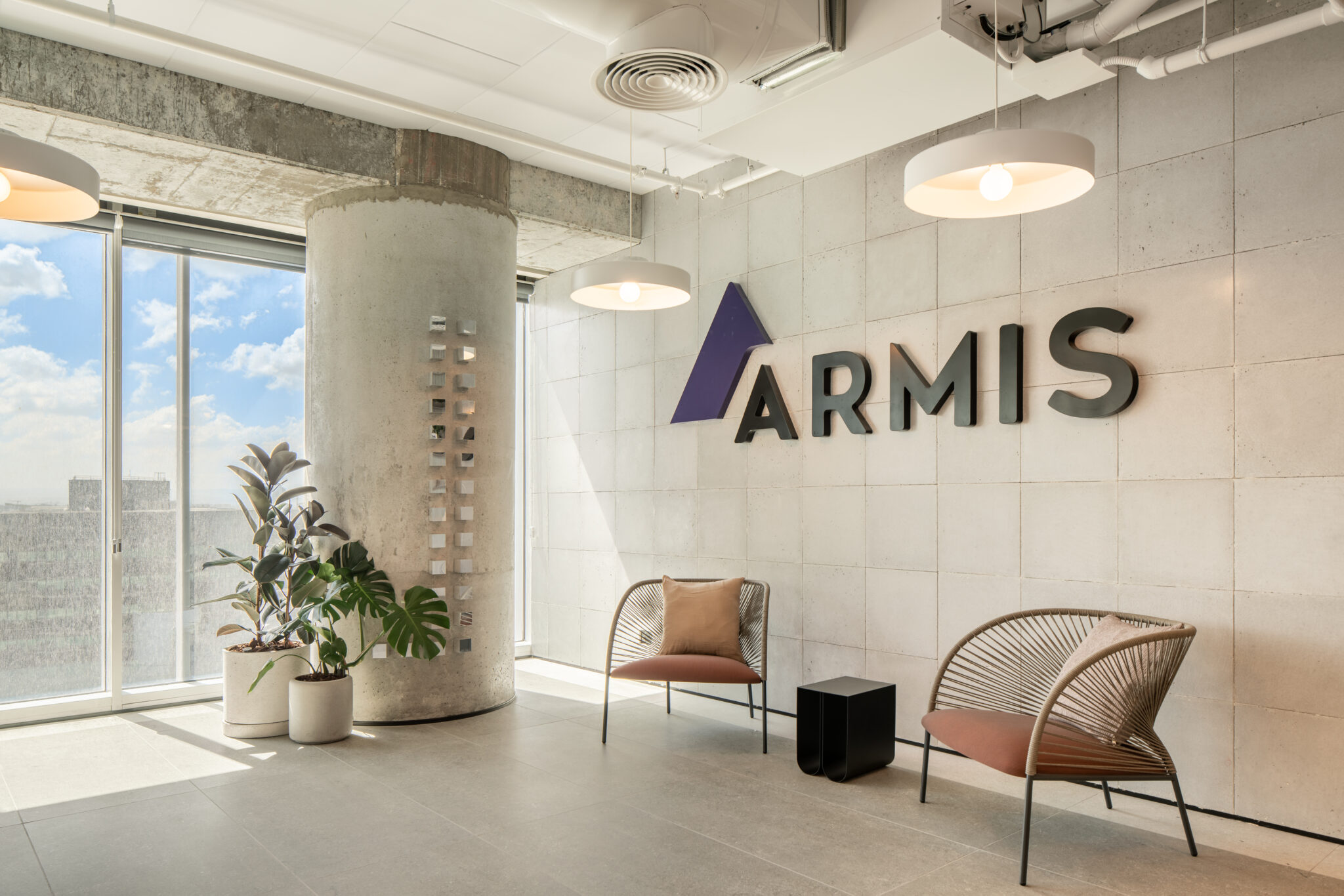 ARMIS 3D logo on a concrete tile reception wall
