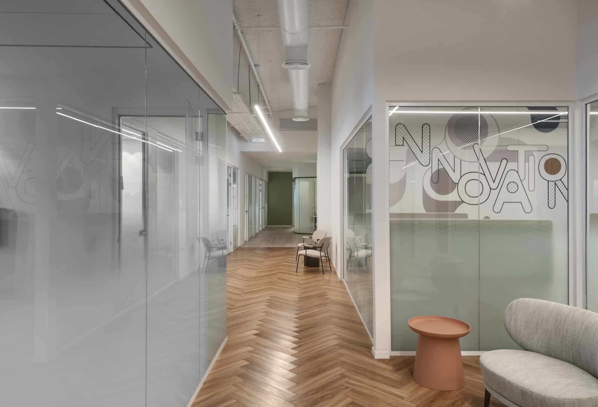 INNOVATION lettering and graphics on frosted glass coating in a corridor