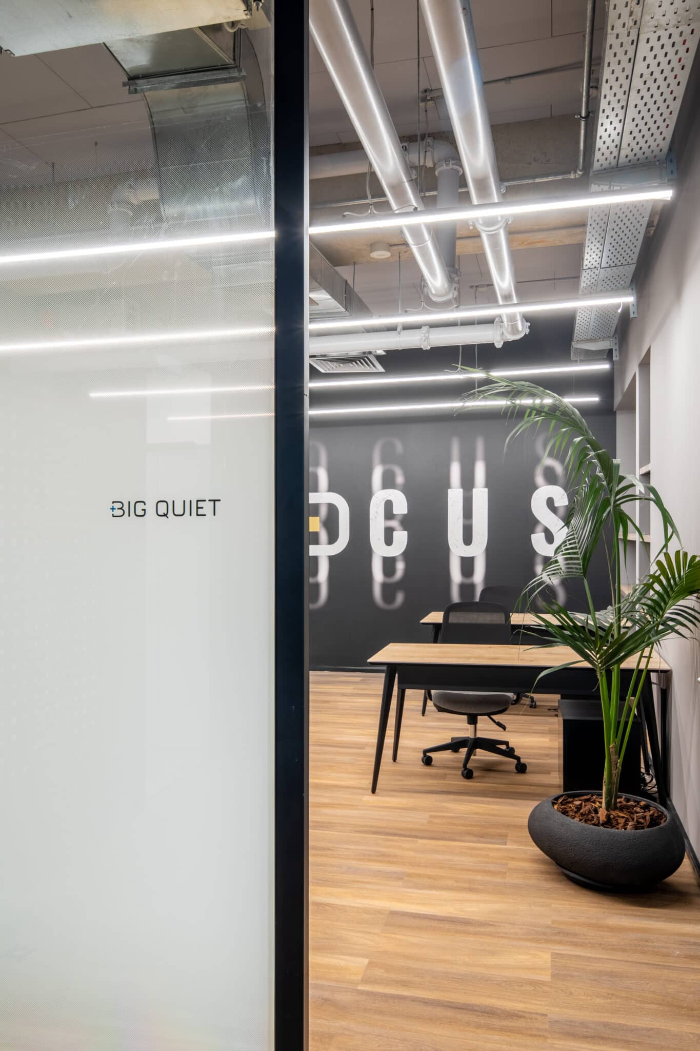 BIG QUIET room name on frosted gradient glass with a FOCUS wall graphic