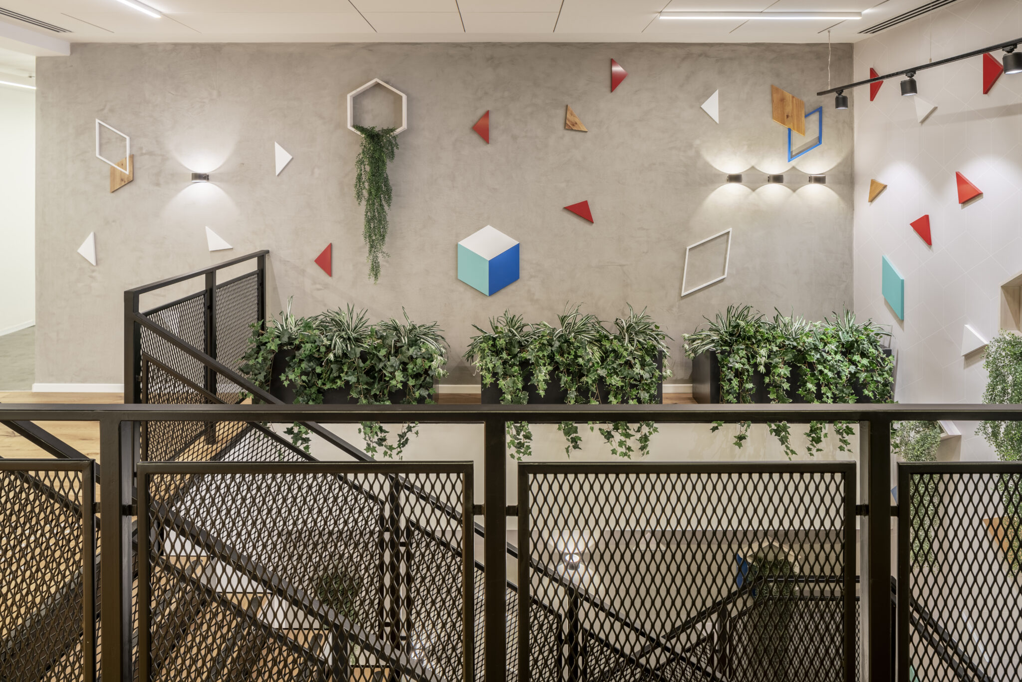 Coloured 3D geometric shapes on a stairwell wall