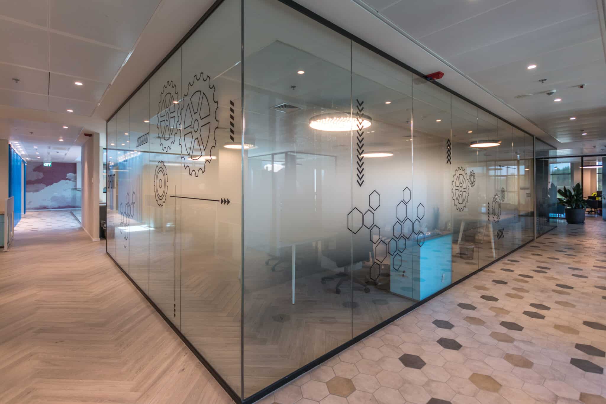 Gear and hexagon graphics printed on meeting room glass