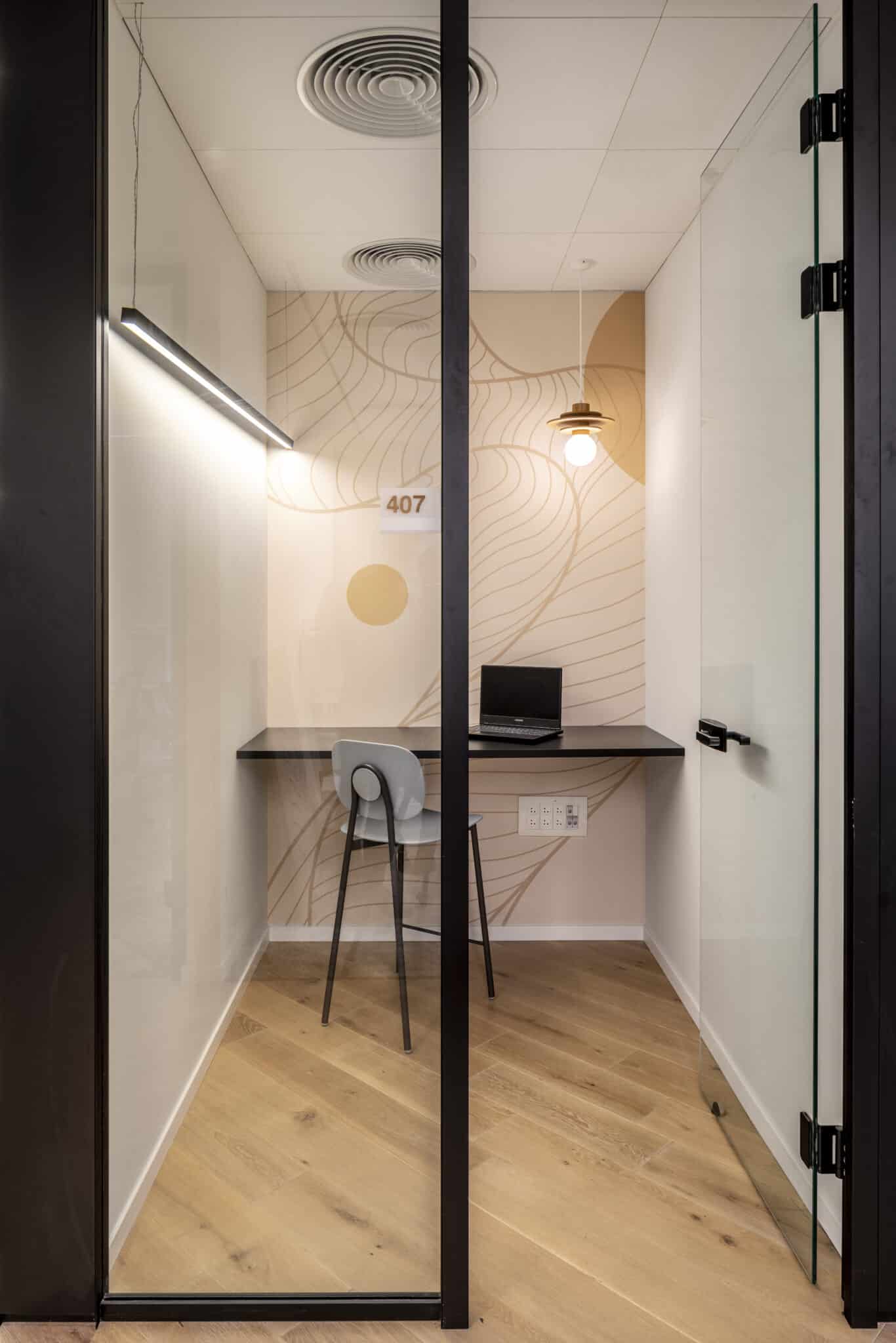 Line wall graphic and room number in a phone booth