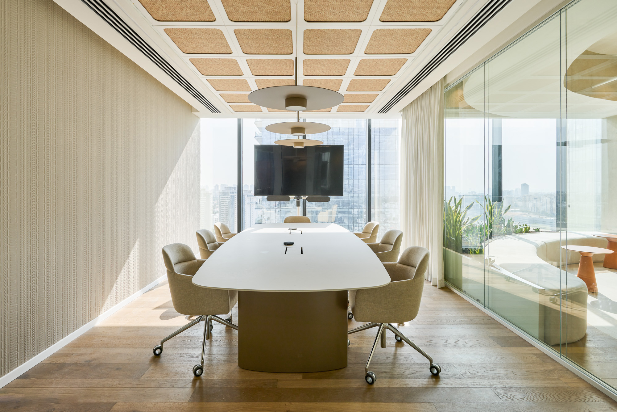 Fabric texture wall panel and cork acoustic ceiling in a meeting room