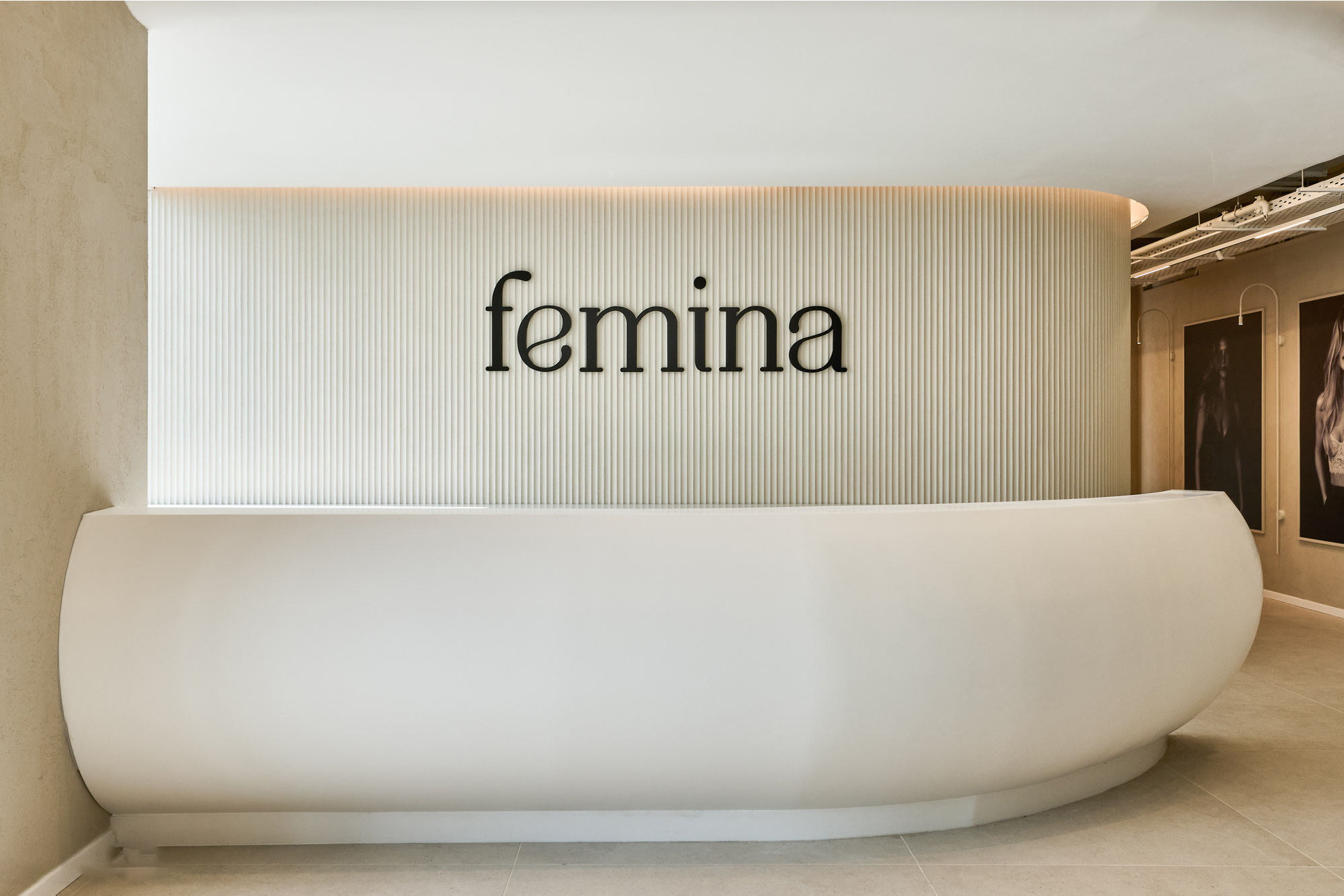 femina 3D logo on a fluted wall above the reception counter