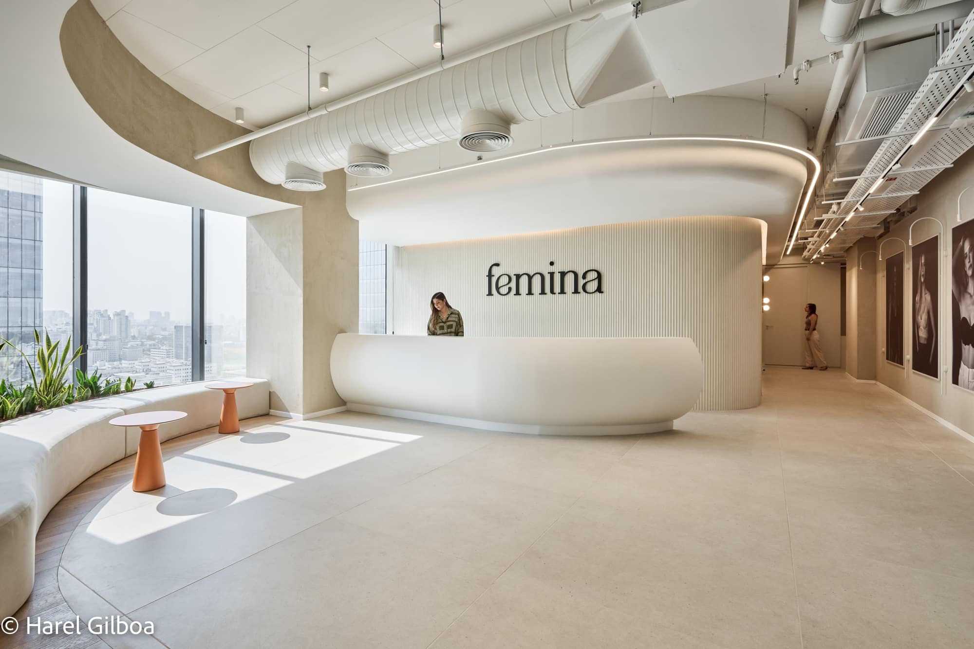 femina logo on a curved fluted reception desk wall