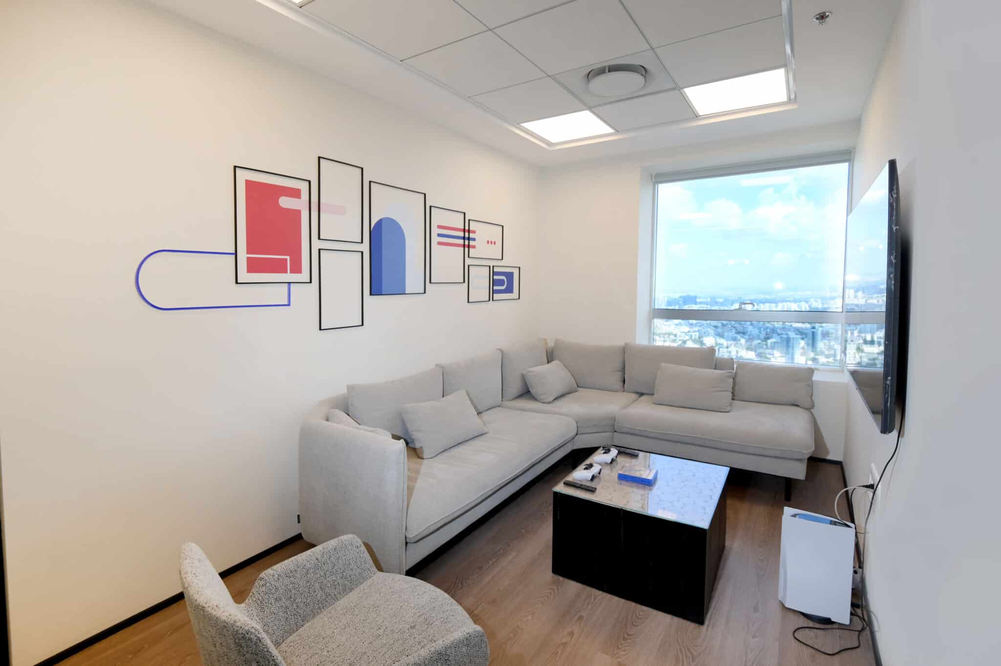 Wall graphic with black frames and a blue line in a lounge