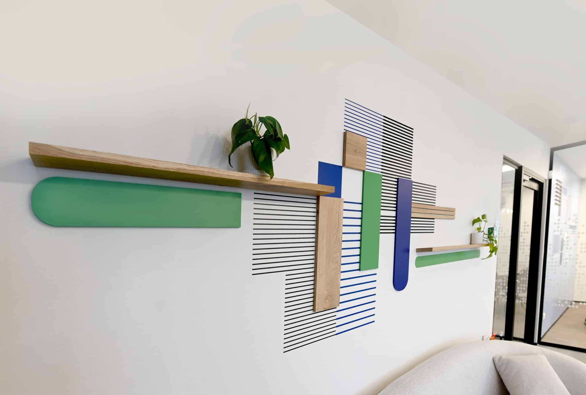 3D wall relief of coloured shapes, wood battens and line graphics
