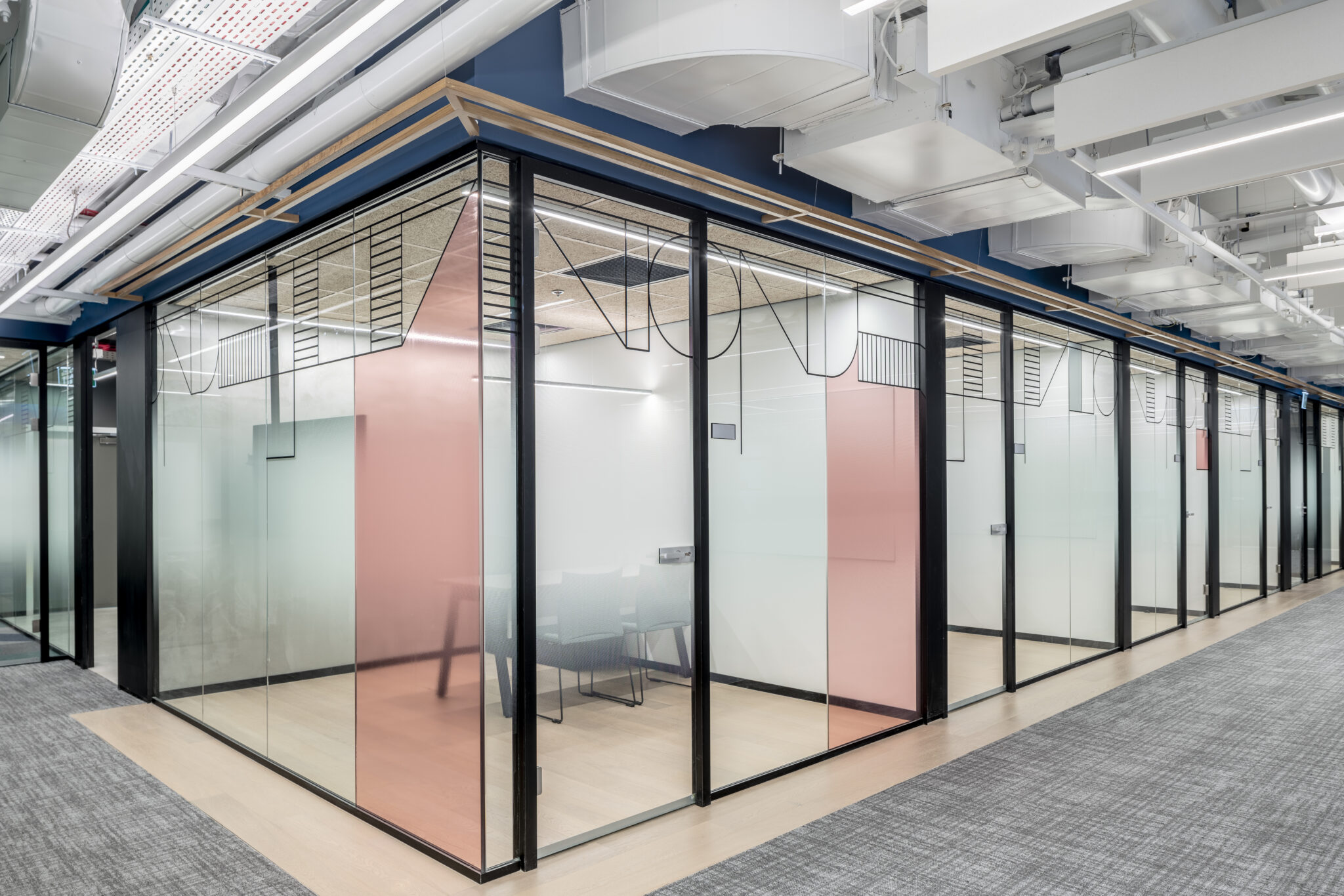 Gradient film in coral and grey on glass meeting room walls