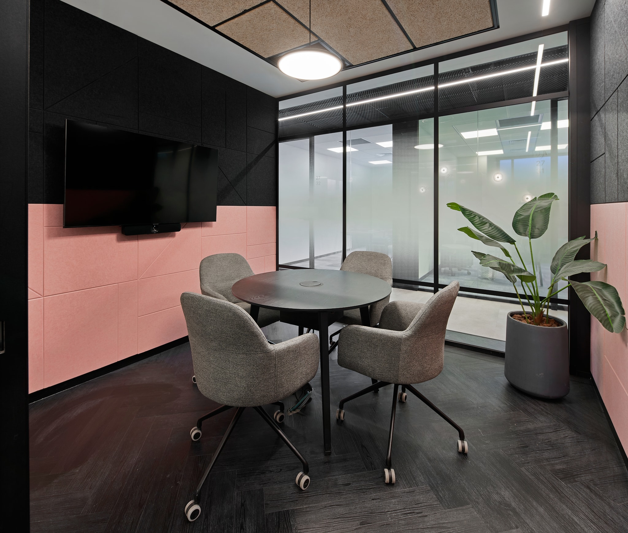 Pink and black wall panels in a small meeting room