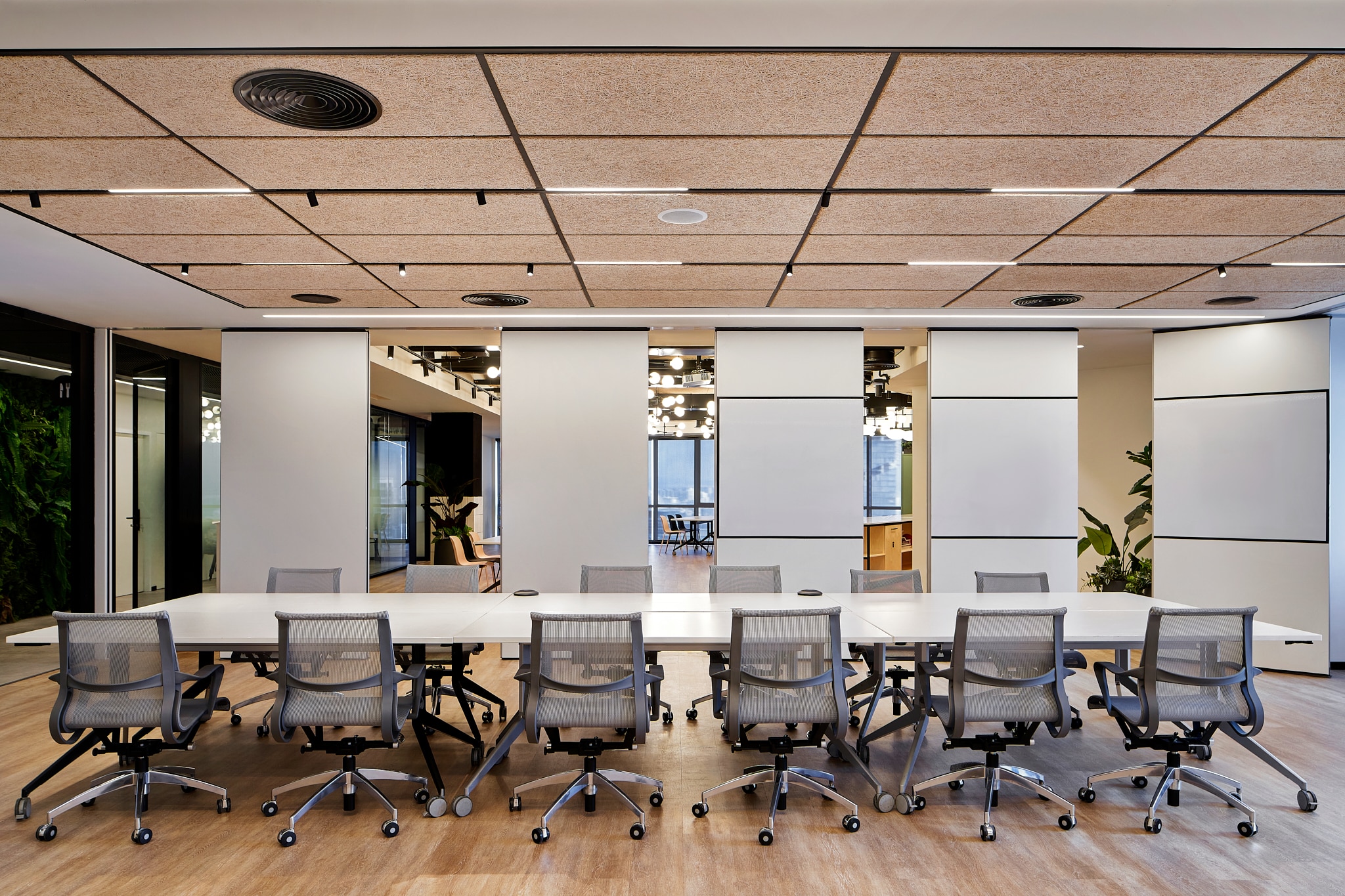 Whiteboard with a black frame across a wide meeting room wall