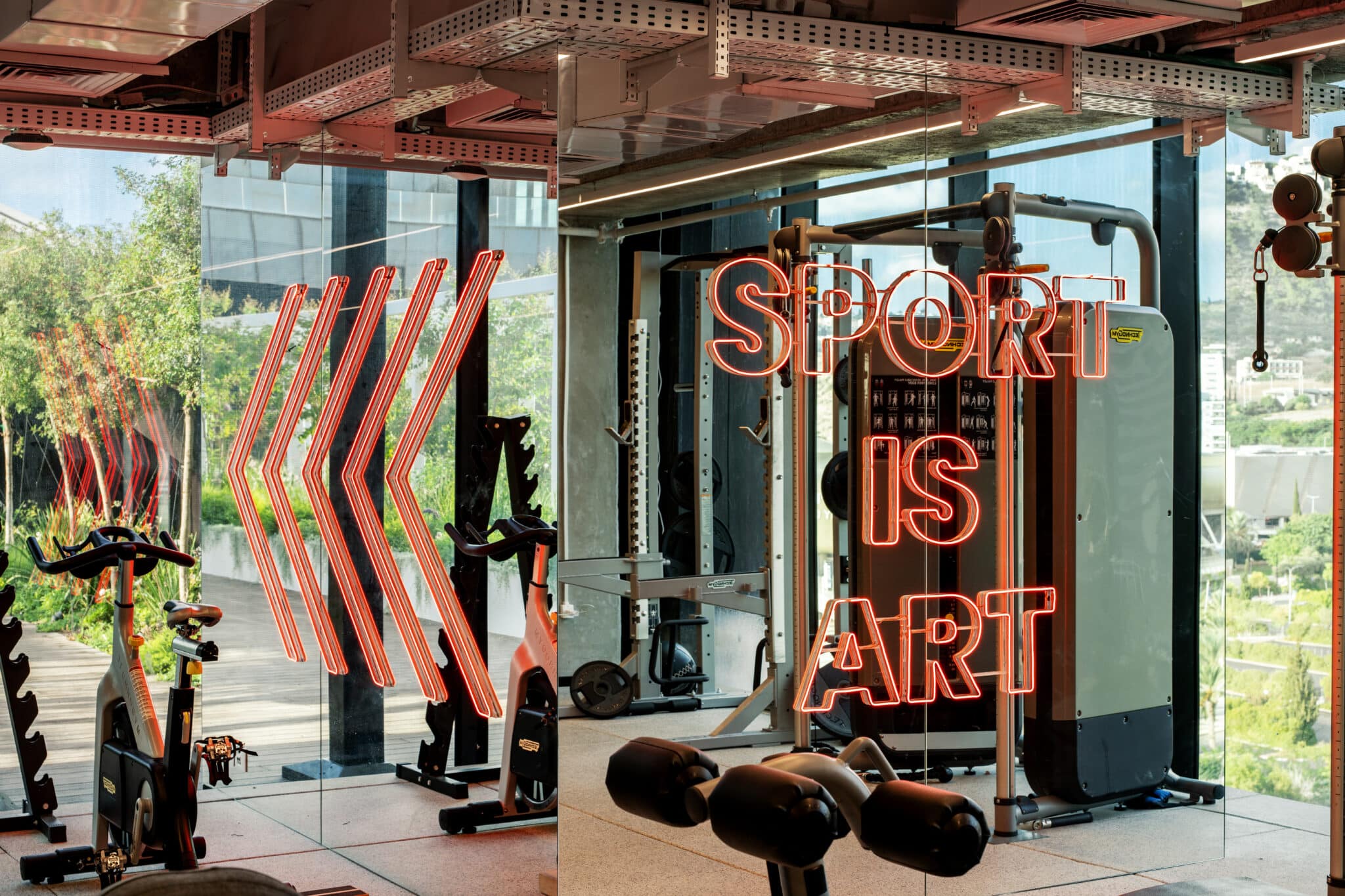 SPORT IS ART neon letters and chevrons in a gym