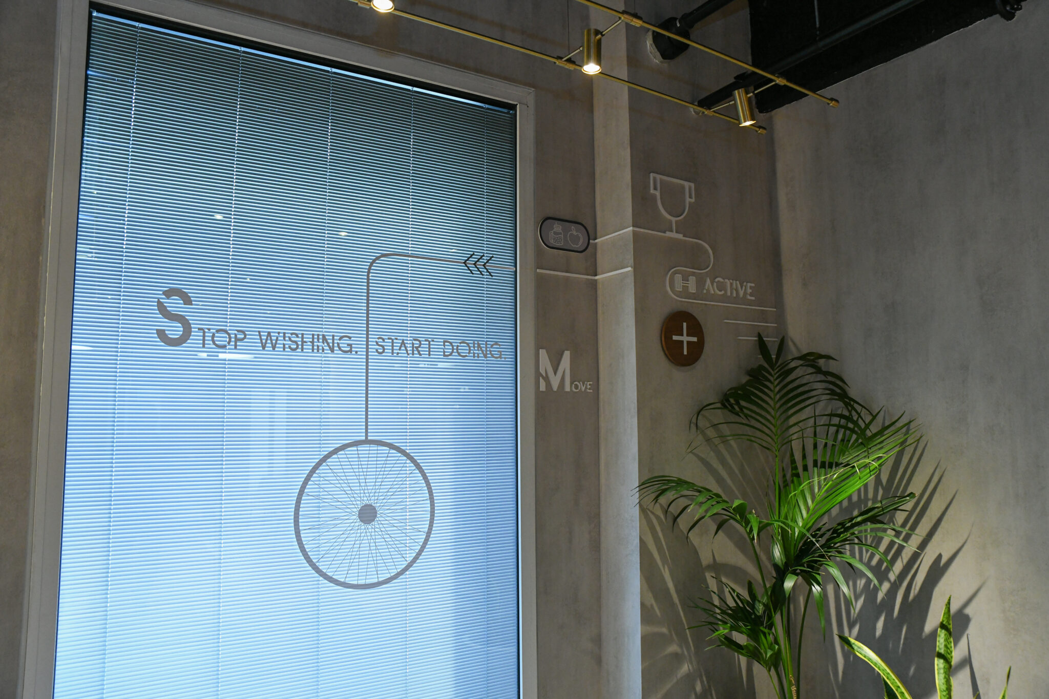 STOP WISHING START DOING graphics printed on glass and wall