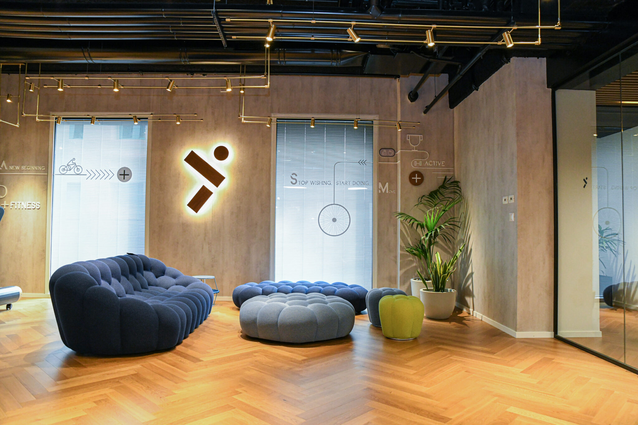 Backlit 3D logo mark and wall graphics in a lounge
