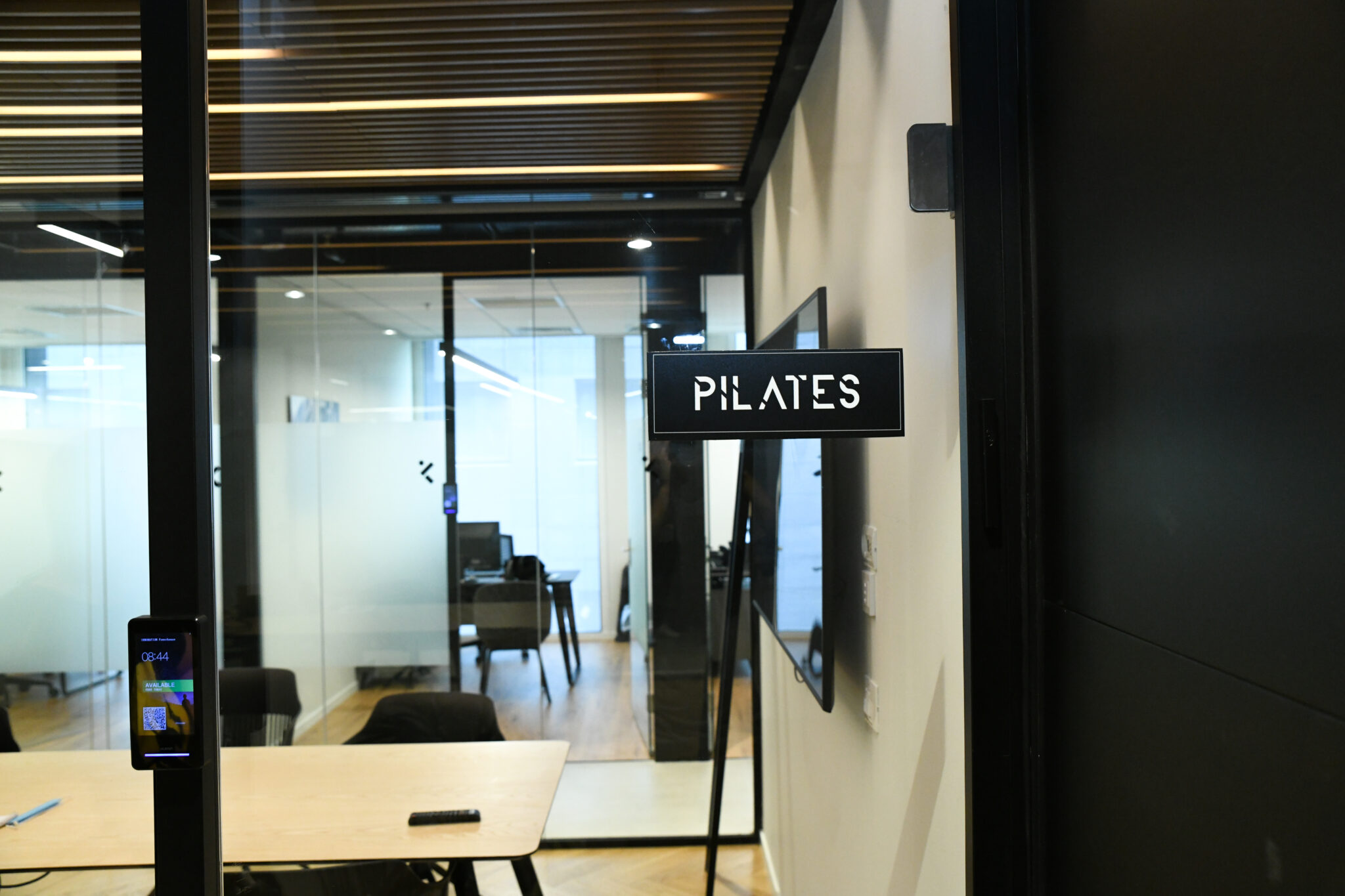 PILATES flag sign mounted on a studio wall