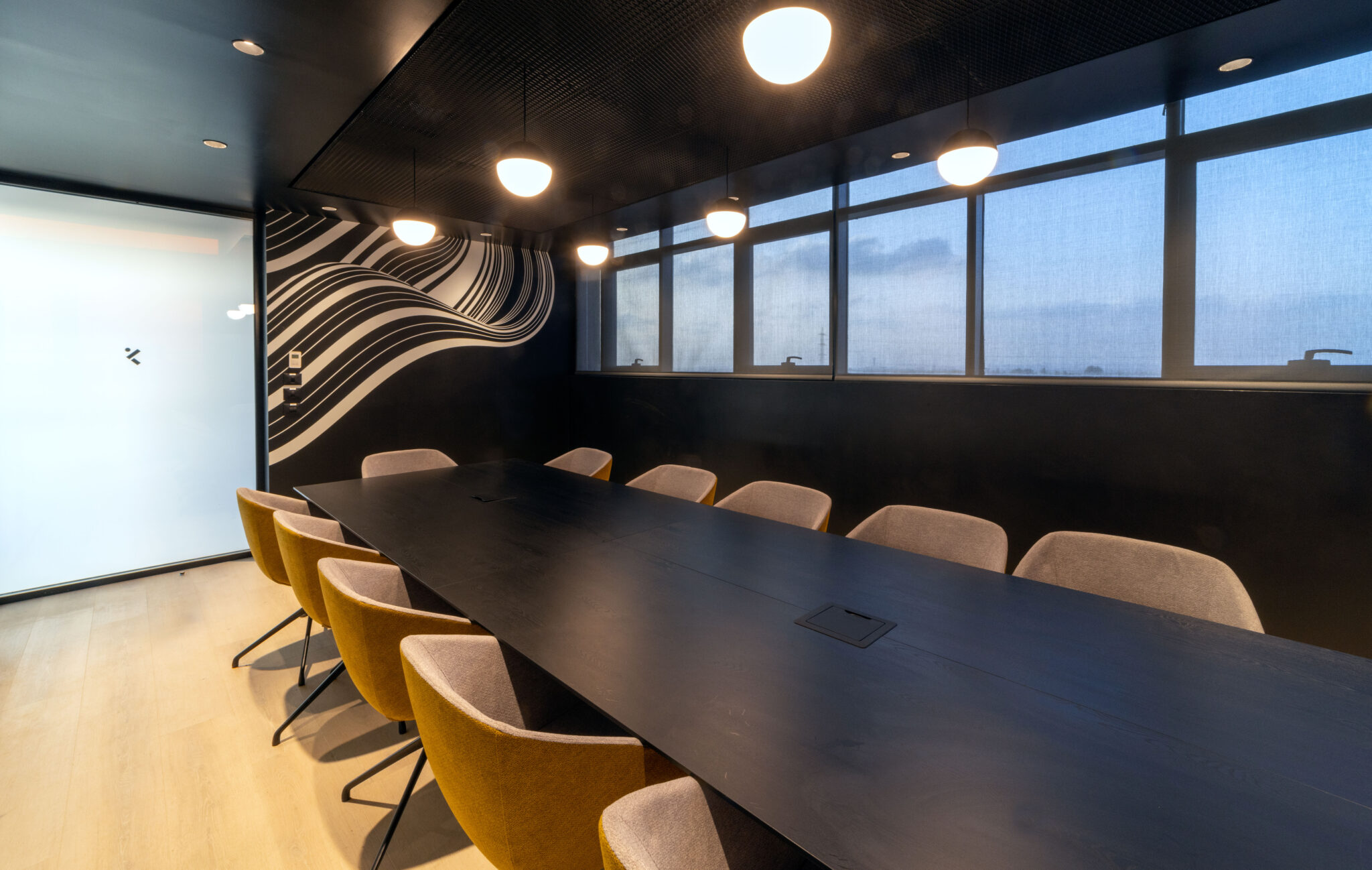 Flowing white line wall graphic in a dark meeting room