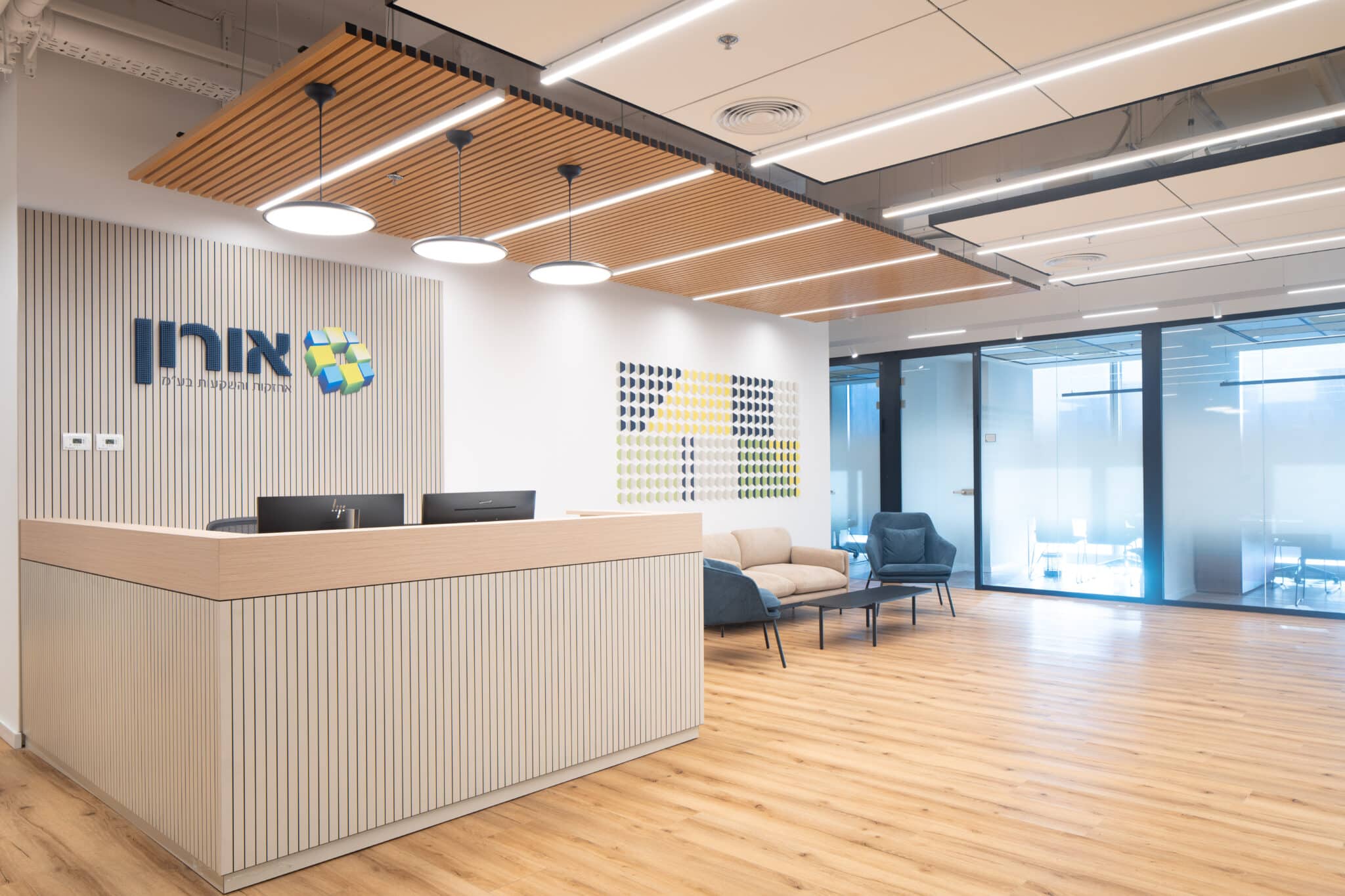 Oron 3D logo on a slatted reception wall beside a tile grid graphic