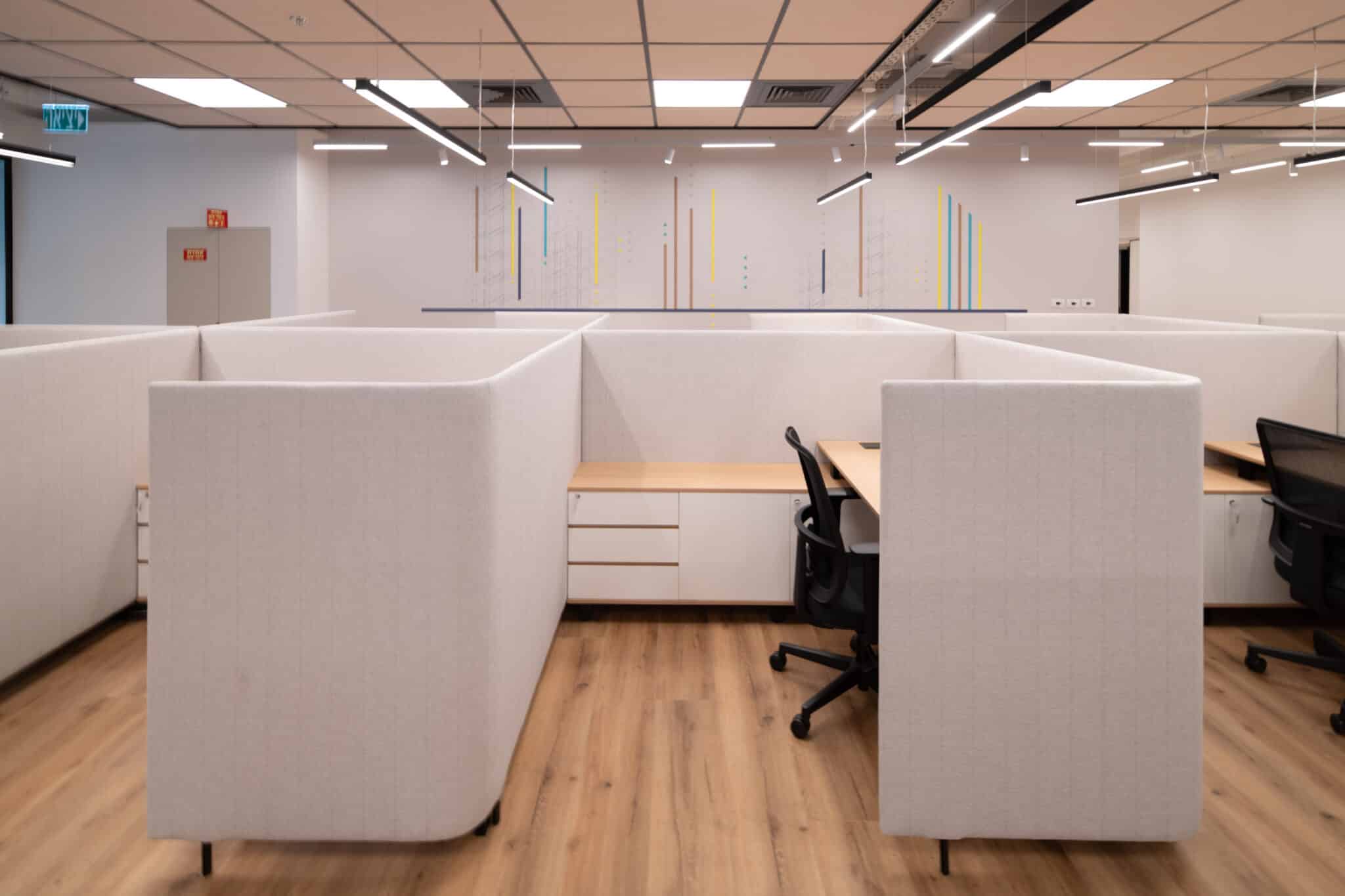 Thin coloured line wall graphic behind open-plan workstations