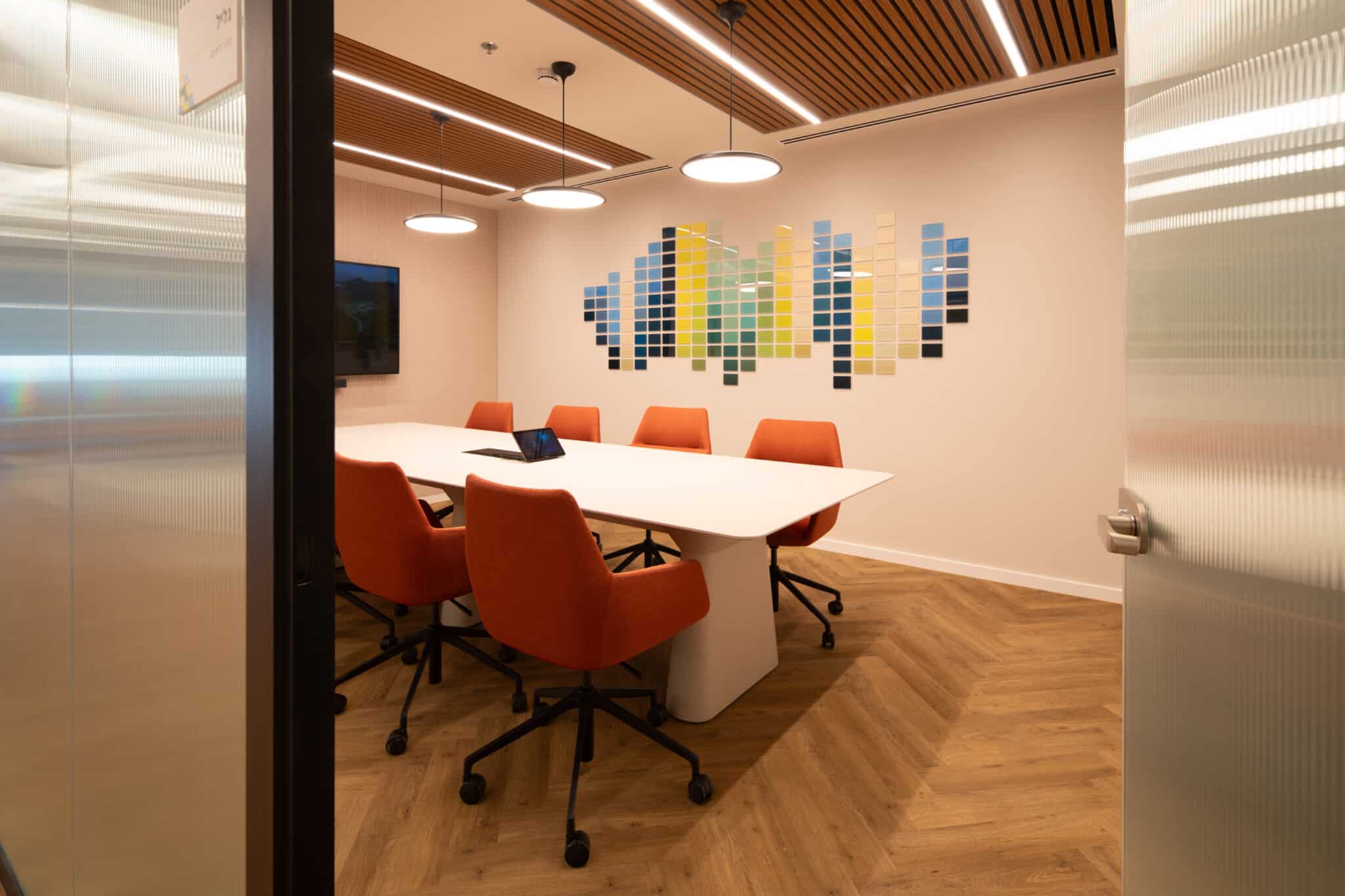 3D tile wall artwork in blue and yellow in a meeting room