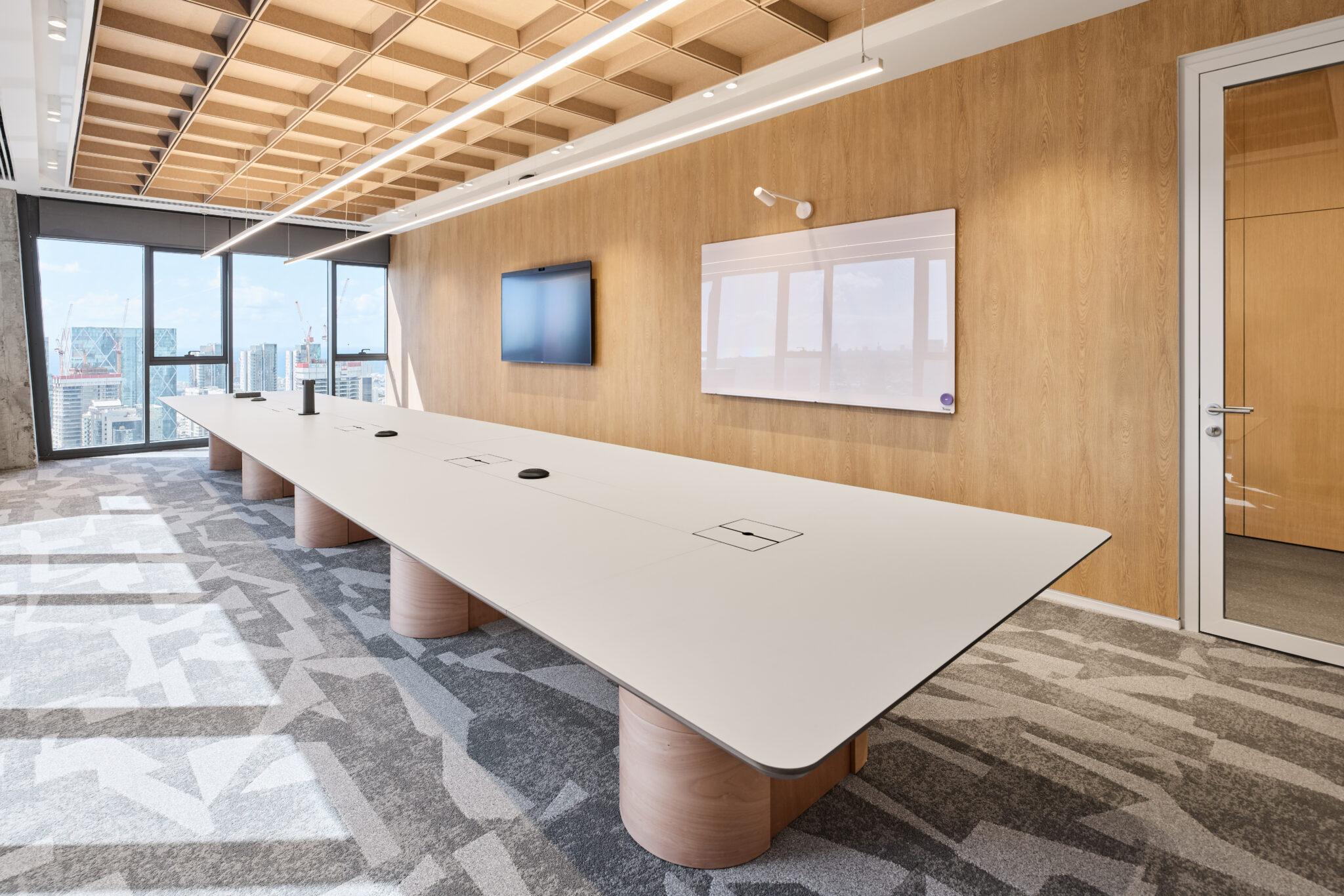 Boardroom with a whiteboard on a wood-clad wall