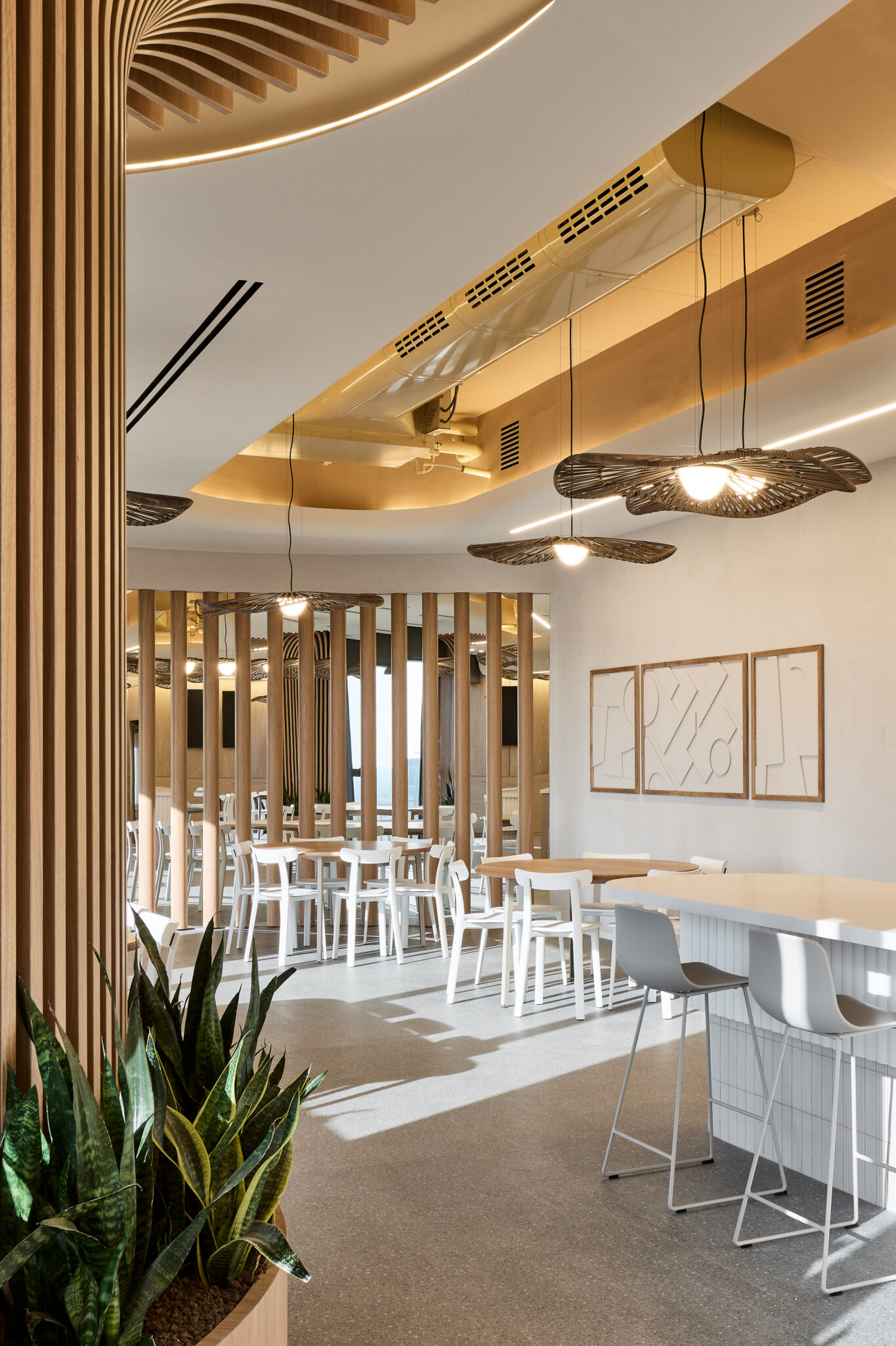 Framed line artwork on a dining area wall beside slatted screens