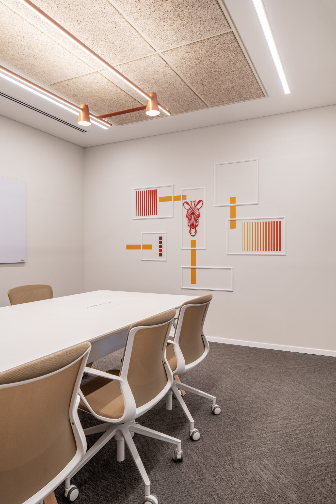 White frames with red and orange graphics in a meeting room
