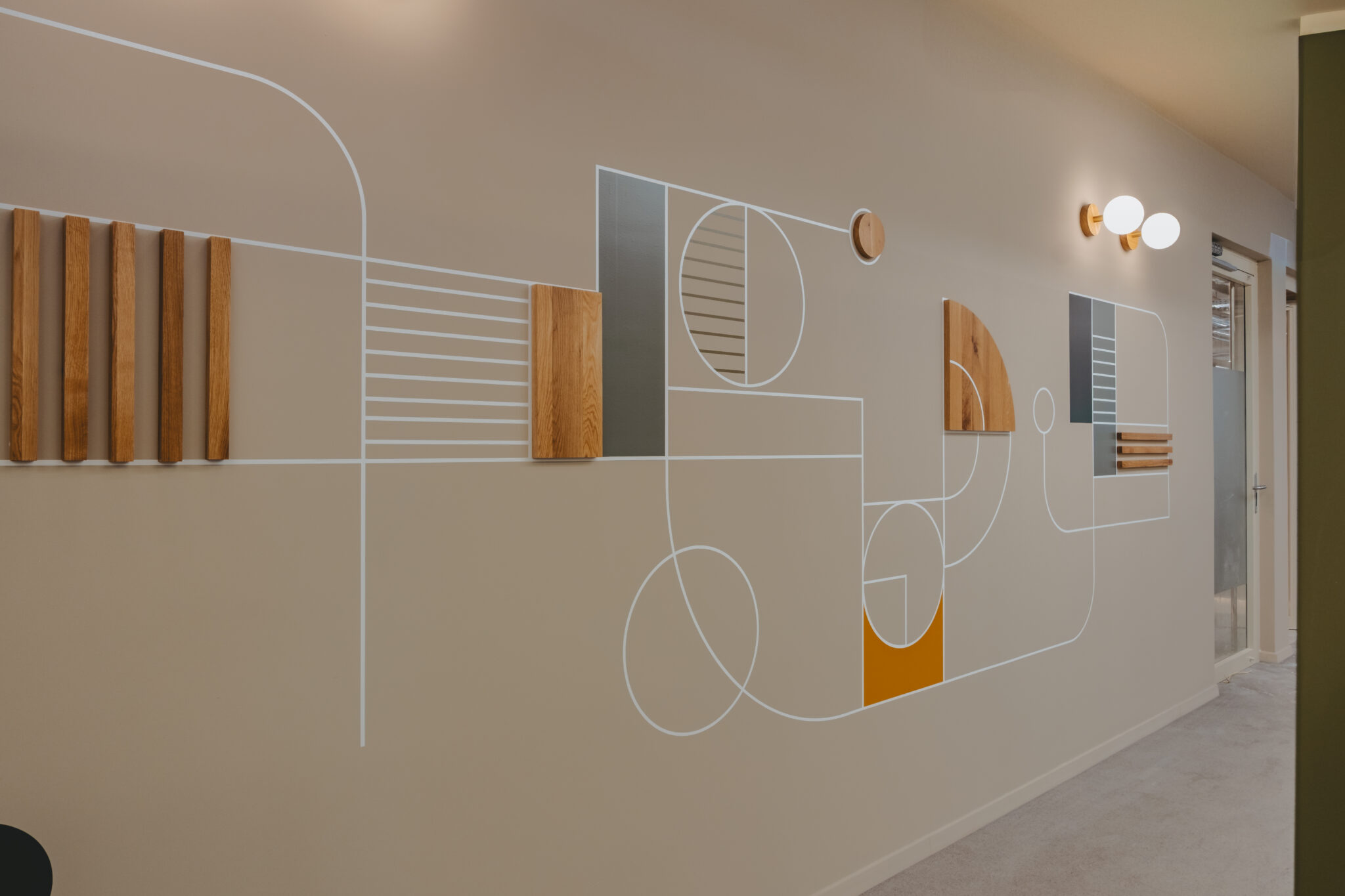 Geometric wall graphic with applied wood strips and discs