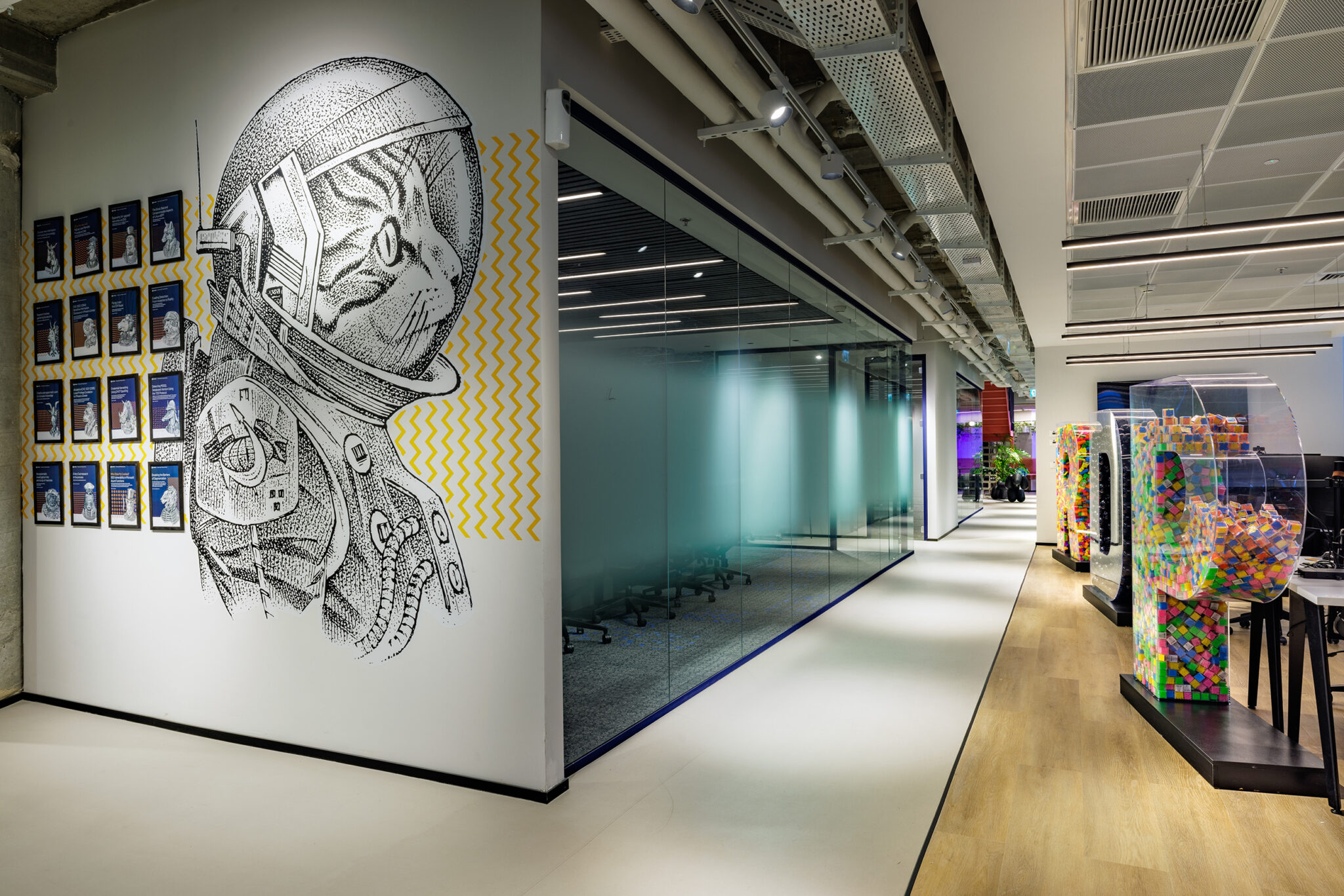 Astronaut line drawing wall graphic with framed prints alongside