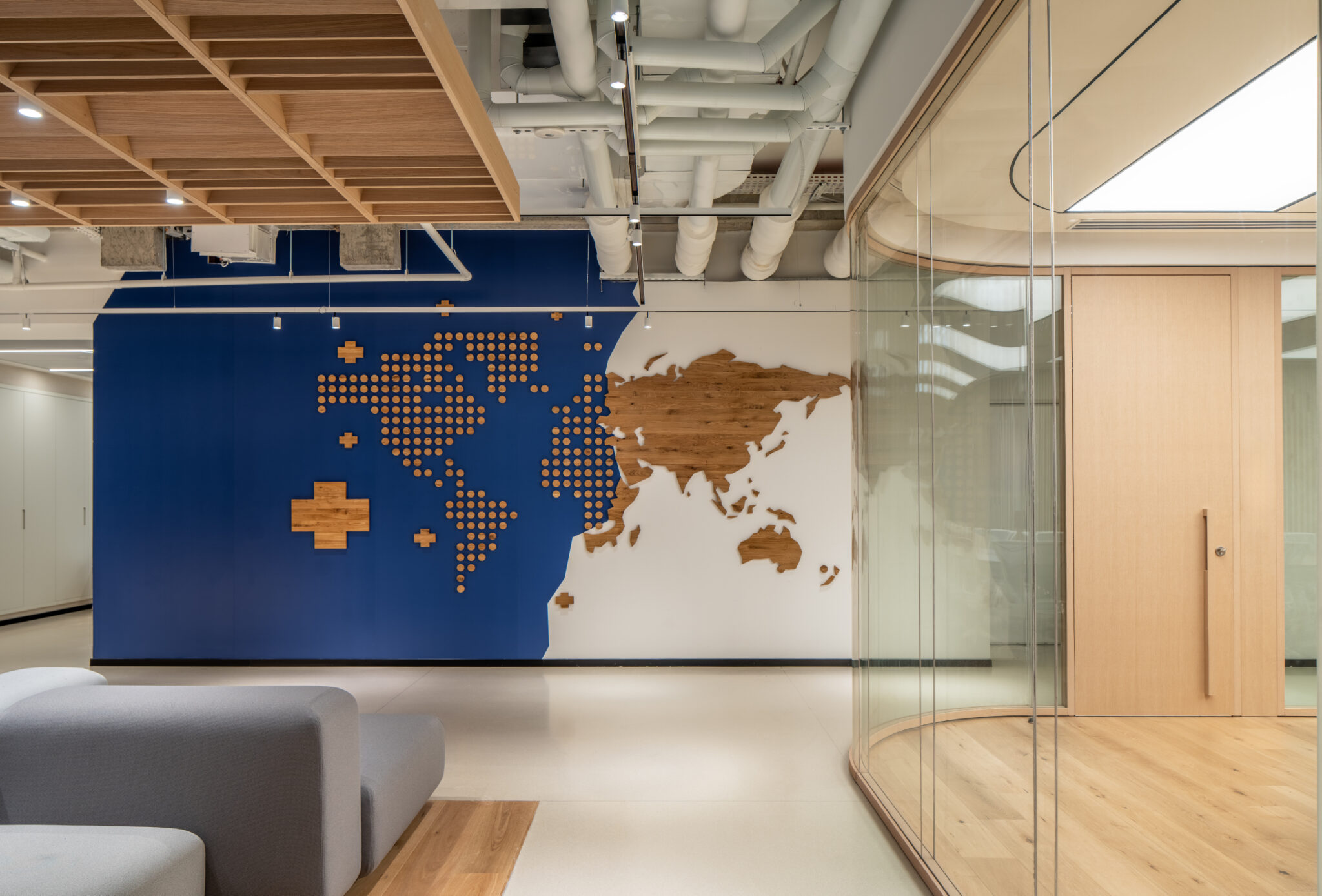 Wood and cross world map wall seen through curved glass