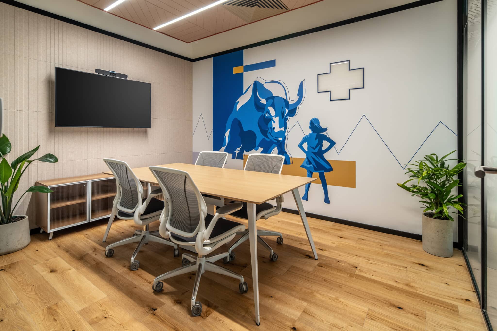 Blue bull and figure wall graphic on a meeting room wall