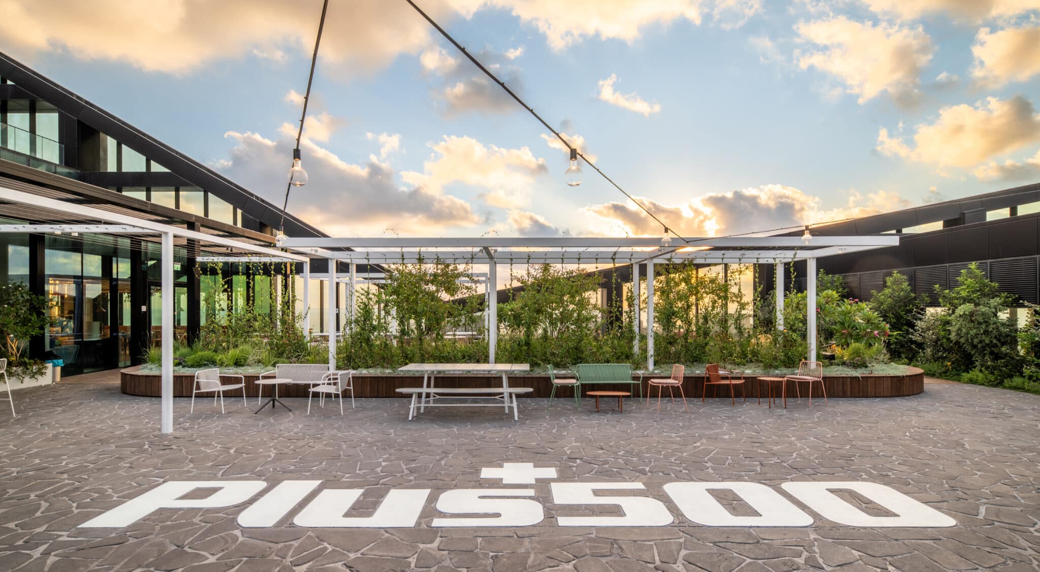 Plus500 logo painted across the rooftop terrace floor