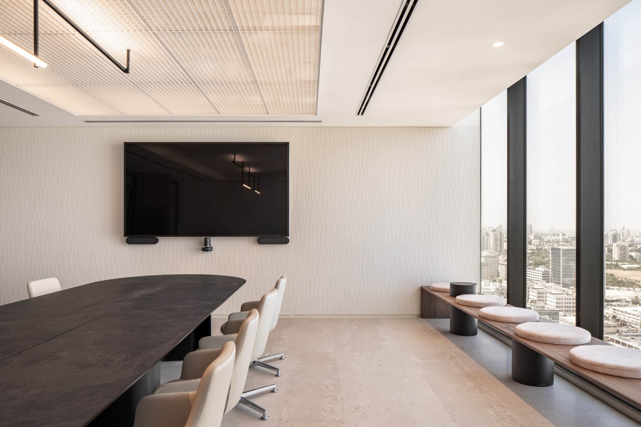 Textured wall covering in a meeting room with a slat ceiling