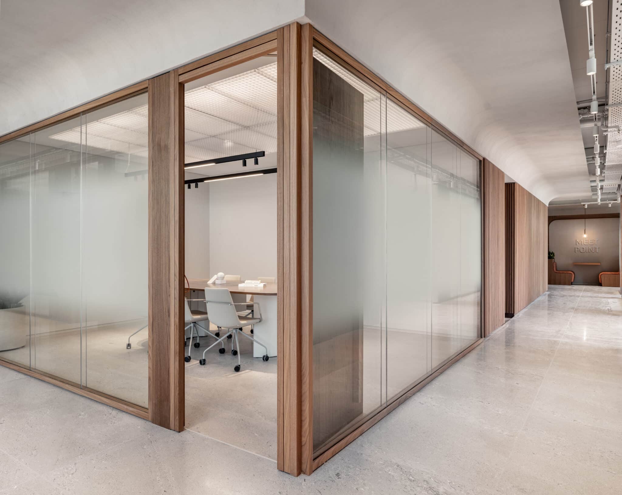 Frosted gradient glass in wood frames around a meeting room