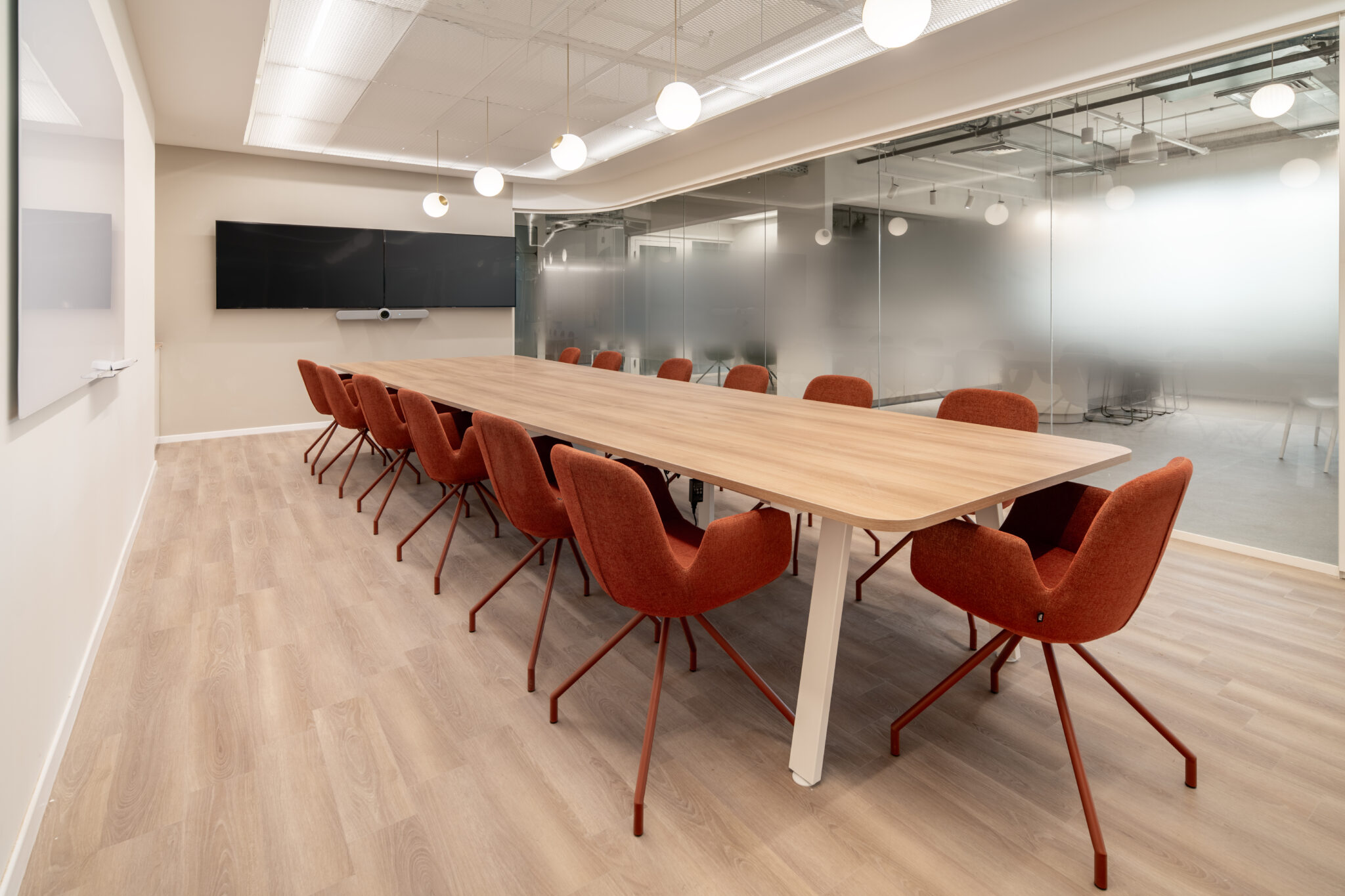 Gradient glass film on meeting room fronts beside a long table