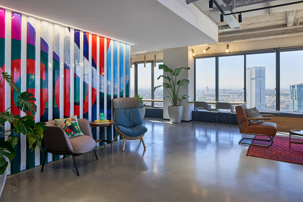 Printed slat wall in bright colours beside a lounge seating area