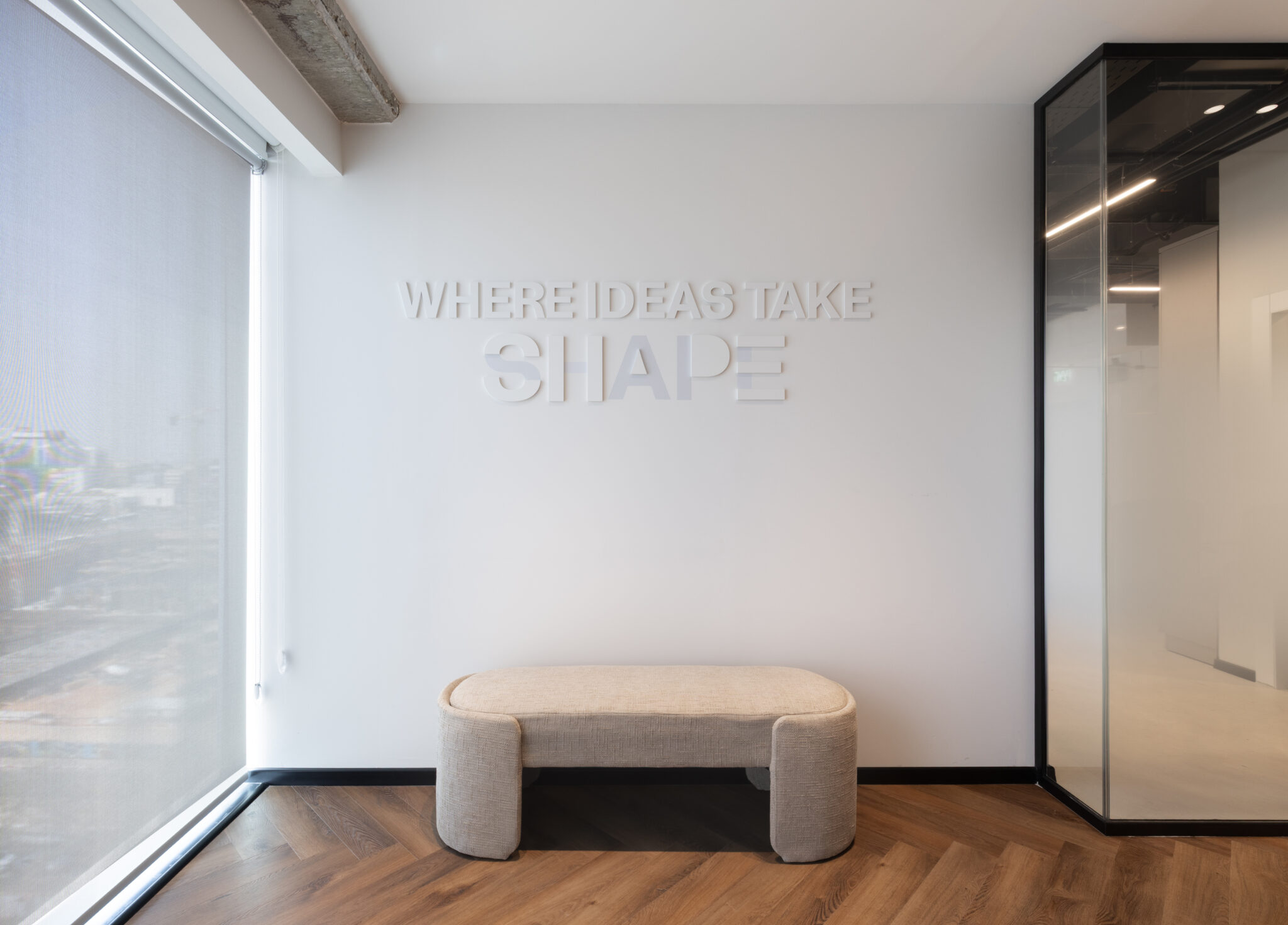 WHERE IDEAS TAKE SHAPE 3D letters on a white wall